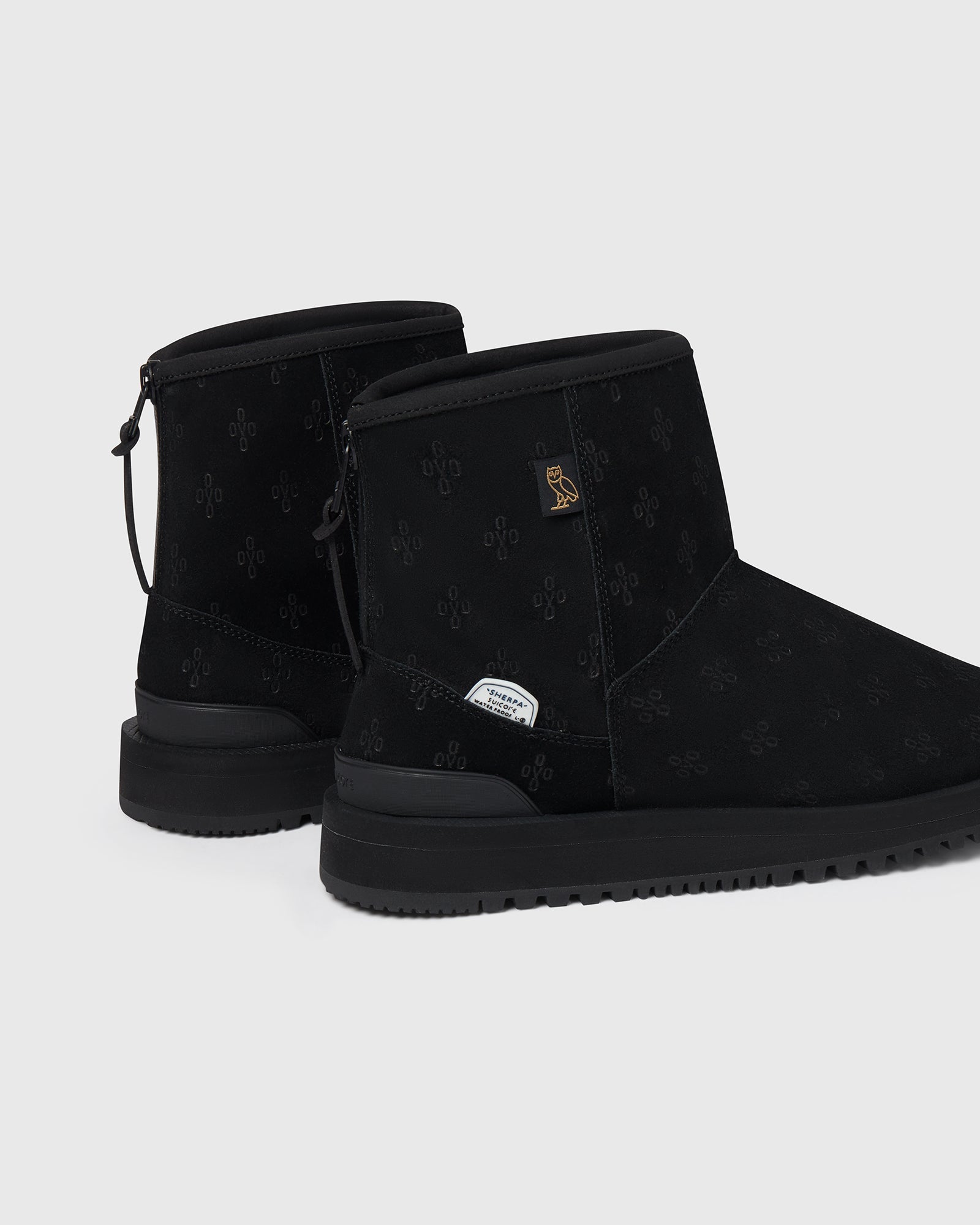 SUICOKE ELS-Mwpab-MID boots with shearling lining, black upper, black midsole and sole, zip closure at heel, OVO monogram debossed pattern, rubberized logo applied in white, tonal rubber trim with embossed logo at heel, antibacterial EVA footbed, and VIBRAM¬¨¬®‚àö√ú arctic grip outsole. From Fall/Winter 2021 collection on SUICOKE Official US & Canada Webstore.