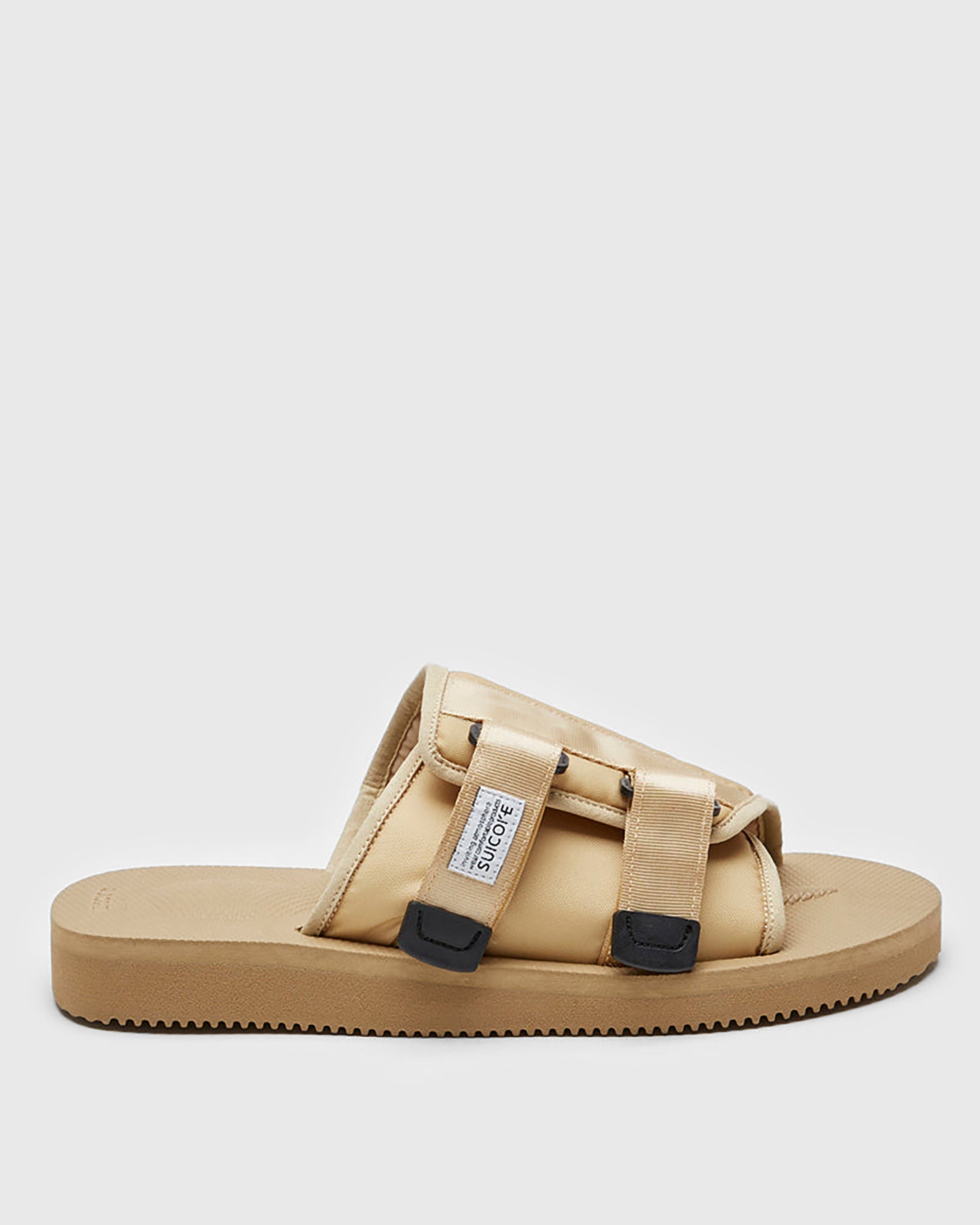 SUICOKE KAW-Cab slides with beige nylon upper, beige midsole and sole, strap and logo patch. From Spring/Summer 2023 collection on SUICOKE Official US & Canada Webstore OG-081CAB BEIGE