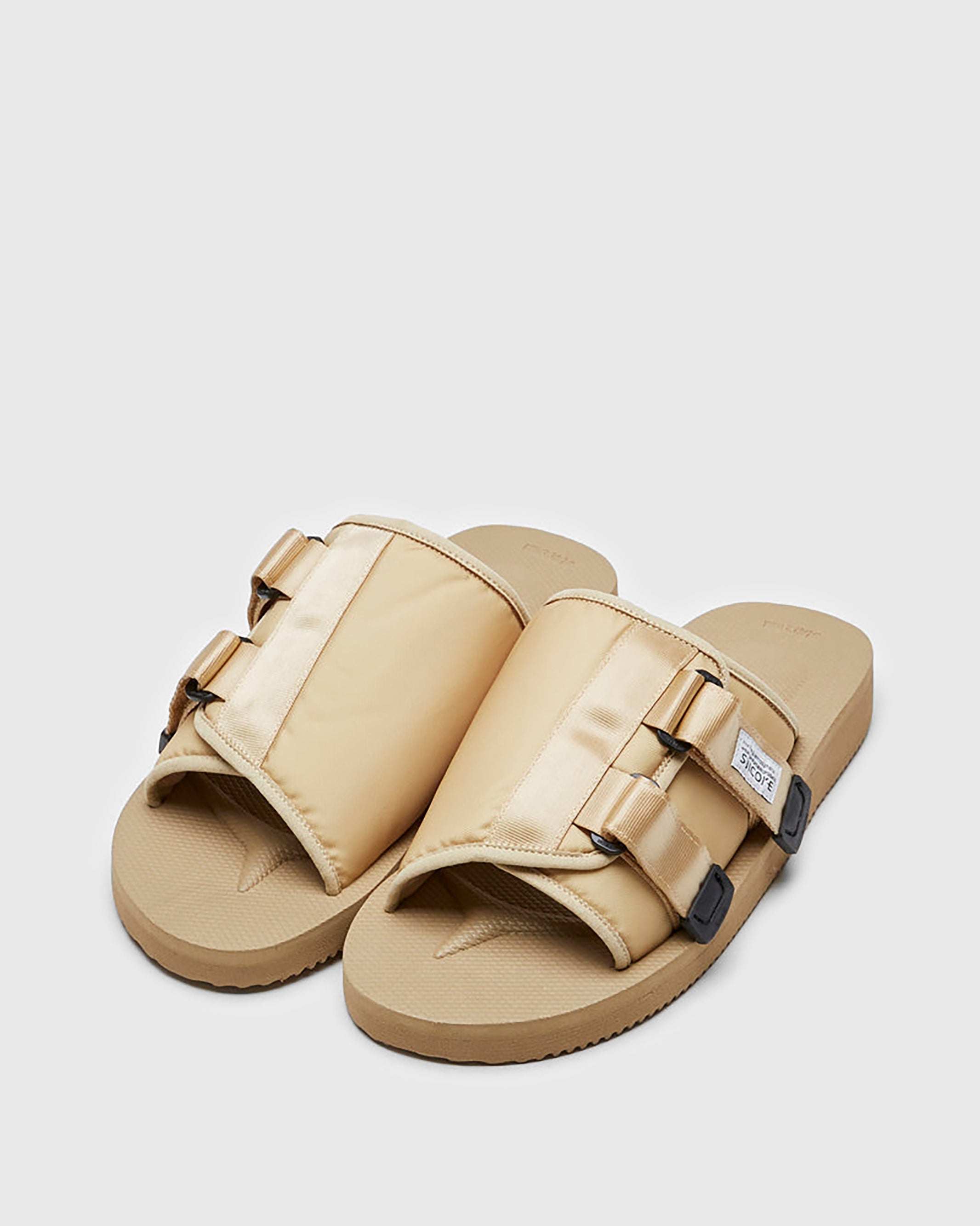 SUICOKE KAW-Cab slides with beige nylon upper, beige midsole and sole, strap and logo patch. From Spring/Summer 2023 collection on SUICOKE Official US & Canada Webstore OG-081CAB BEIGE