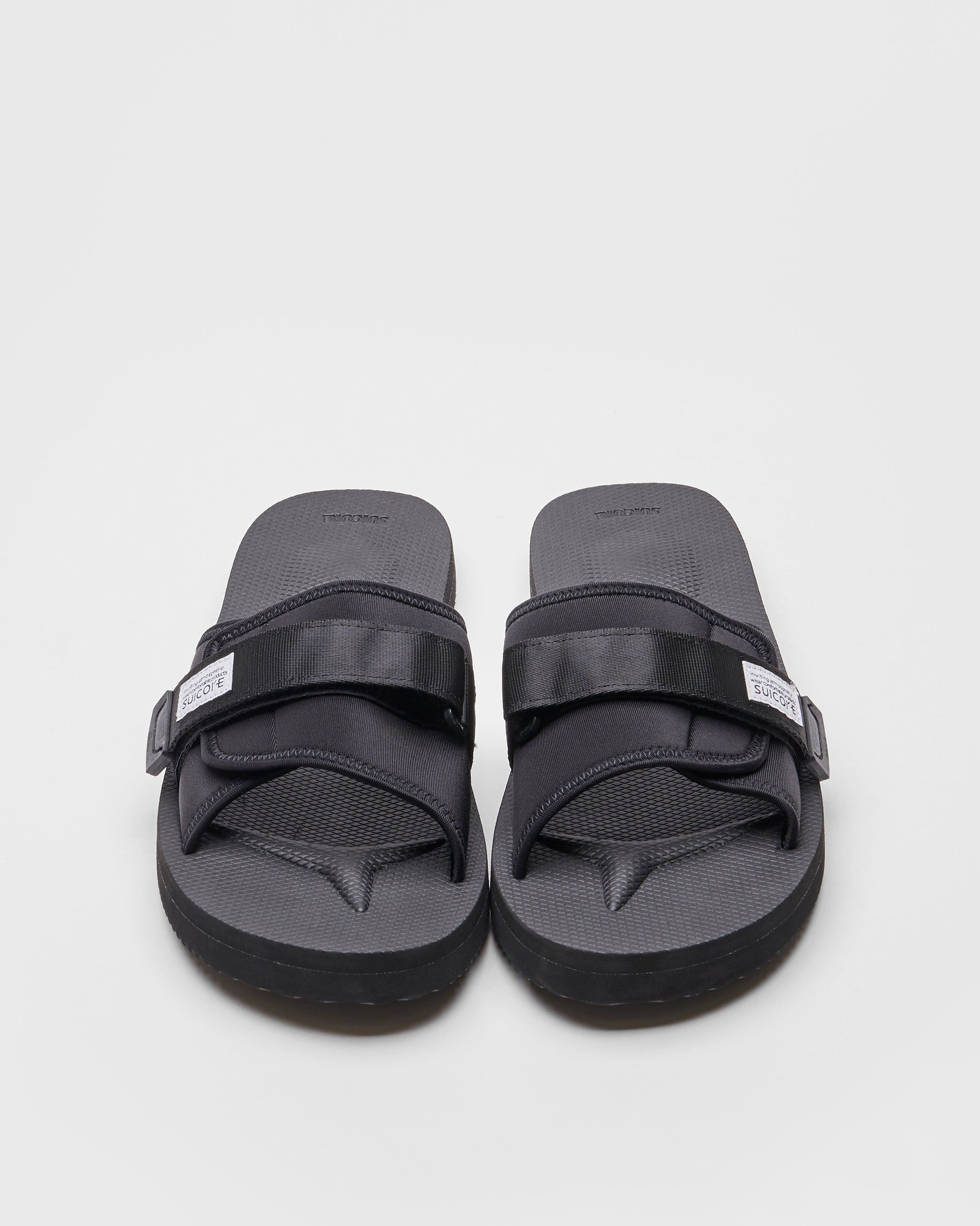 SUICOKE PADRI slides with black calf hair upper, black midsole and sole, strap and logo patch. From Spring/Summer 2022 collection on SUICOKE Official US & Canada Webstore.