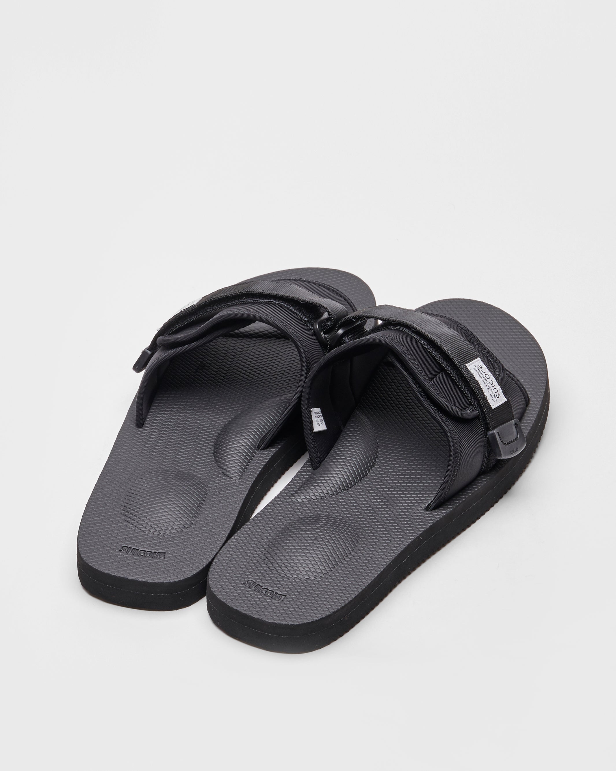 SUICOKE PADRI slides with black calf hair upper, black midsole and sole, strap and logo patch. From Spring/Summer 2022 collection on SUICOKE Official US & Canada Webstore.