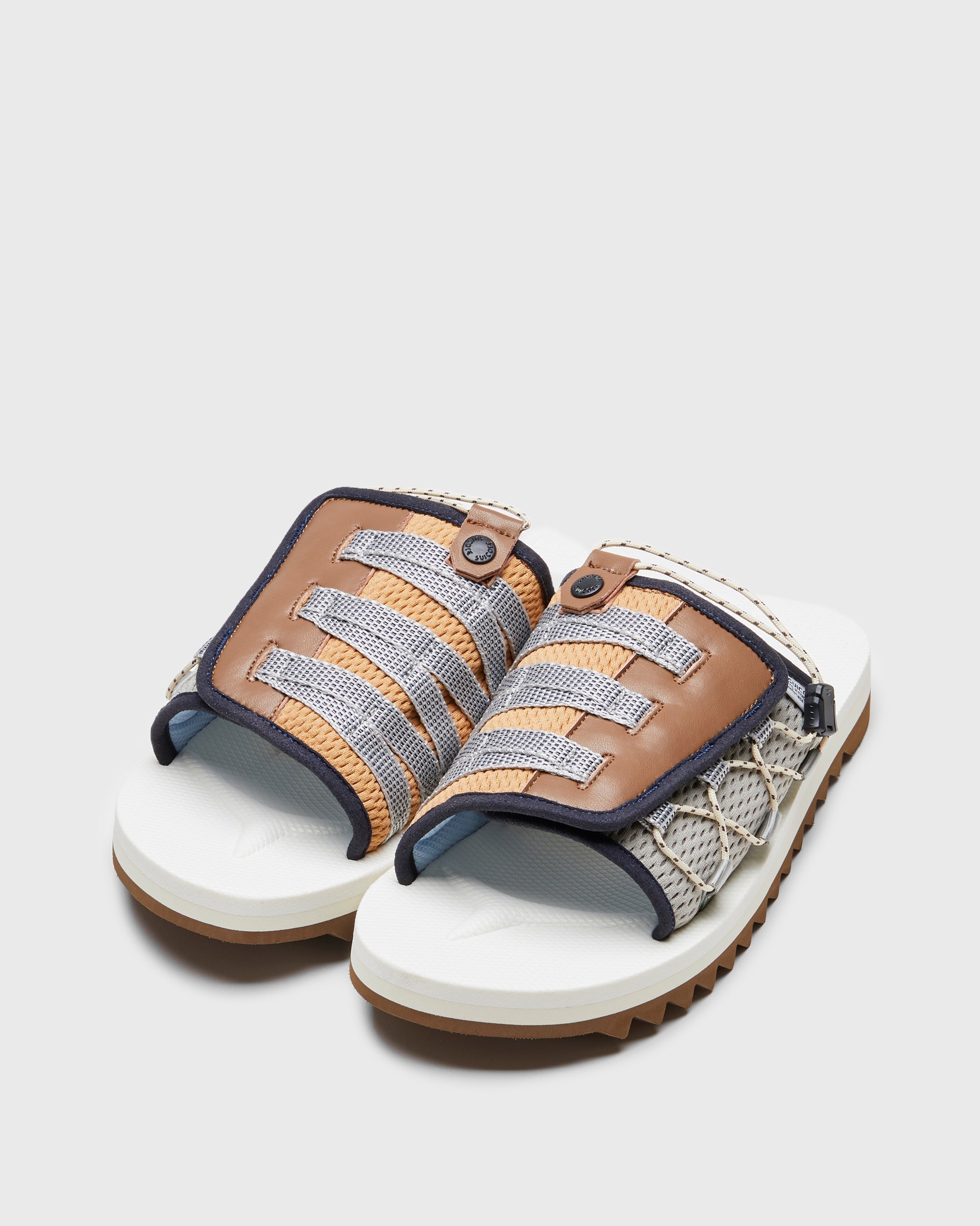 SUICOKE DAO-2AB slides with navy & white nylon upper, navy & white midsole and sole, strap and logo patch. From Spring/Summer 2023 collection on SUICOKE Official US & Canada Webstore. OG-195-2AB NAVY X WHITE