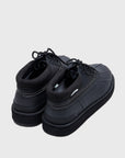 SUICOKE ALAL-Wpab-LO low-top black boot in faux leather upper + rubber duck boot with white contrast stitching. Including black cord laces and pull tab at heel. From Fall/Winter 2021 collection on SUICOKE Official US & Canada Webstore.