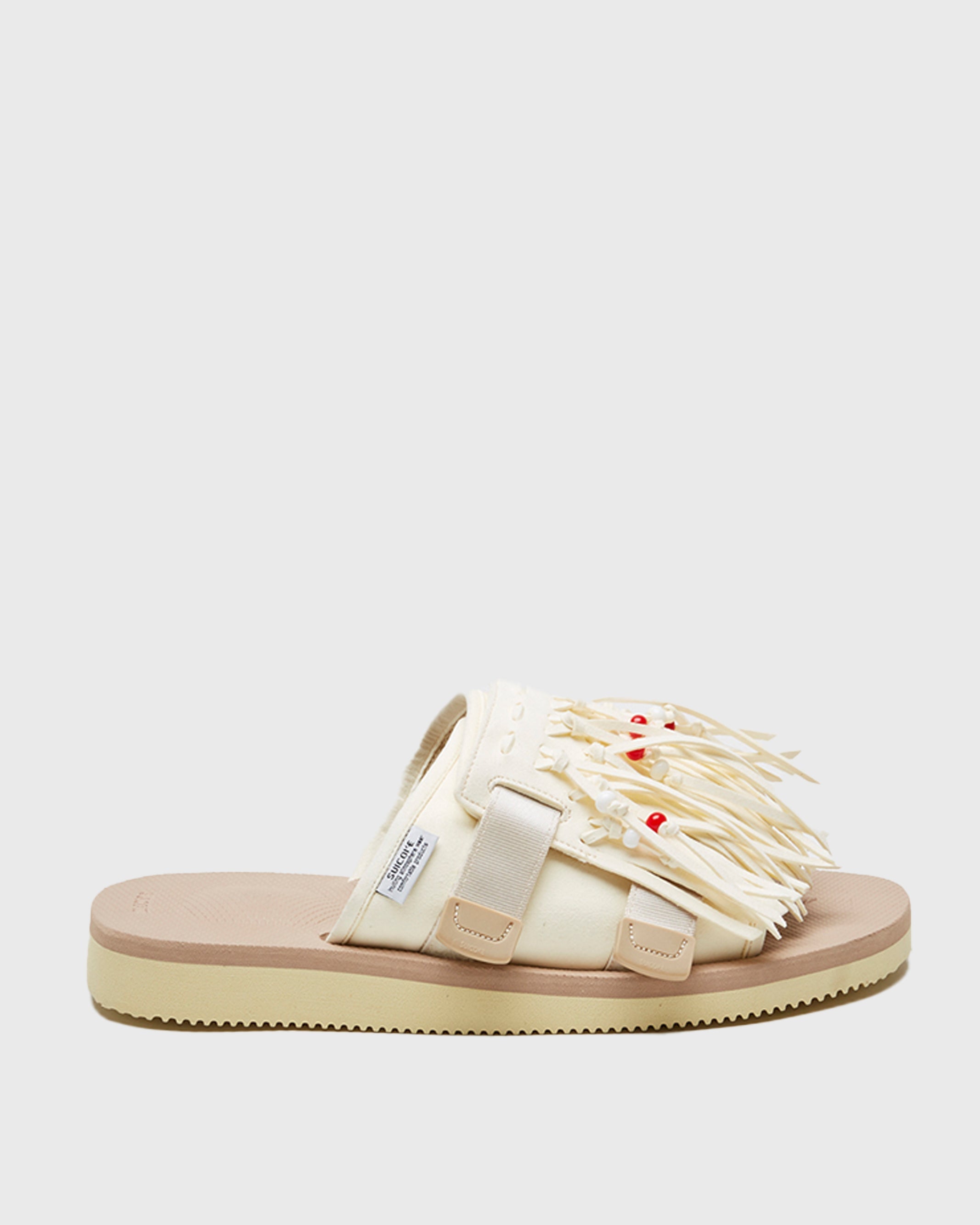 SUICOKE HOTO-Cab slides with offwhite PU suede and nylon upper, beige midsole and sole, straps and logo patch. From Spring/Summer 2022 collection on SUICOKE Official US & Canada Webstore.