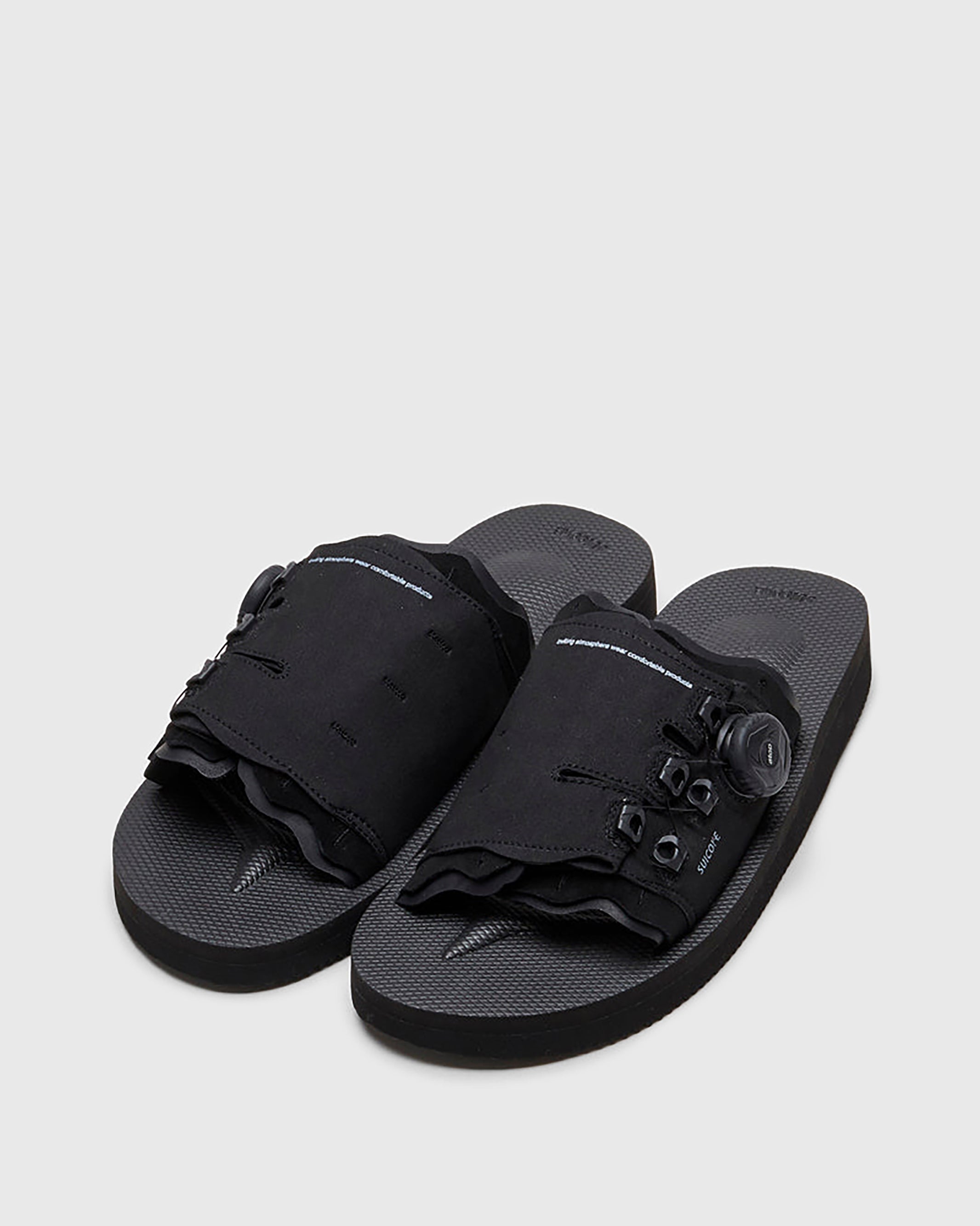 SUICOKE LETA-ab slides with black PU suede upper, black midsole and sole, laces and logo patch. From Spring/Summer 2022 collection on SUICOKE Official US & Canada Webstore.