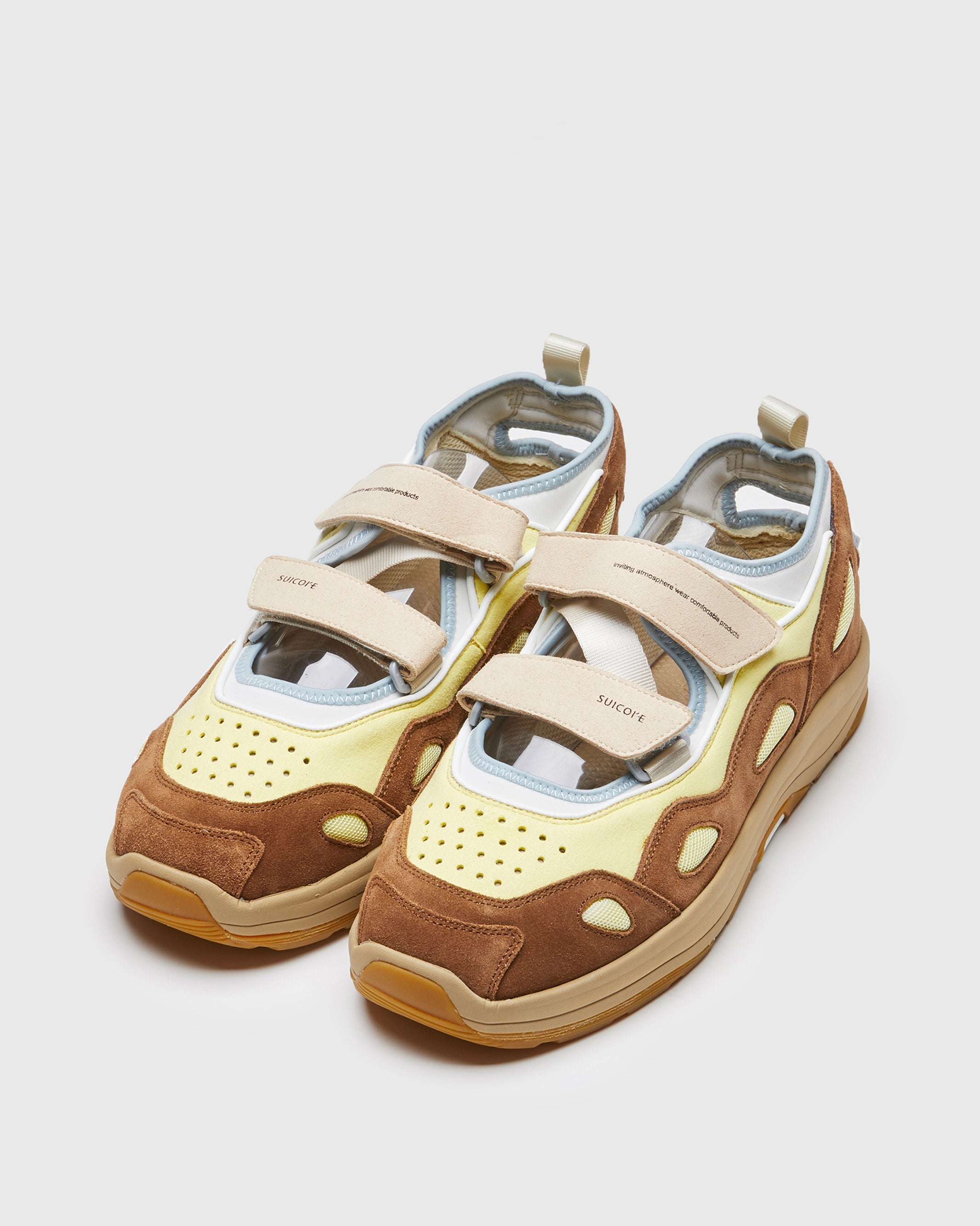 SUICOKE AKK-ab sneakers with brown & yellow nylon upper, brown & yellow midsole and sole, strap and logo patch. From Spring/Summer 2023 collection on SUICOKE Official US & Canada Webstore. OG-285AB BROWN X YELLOW