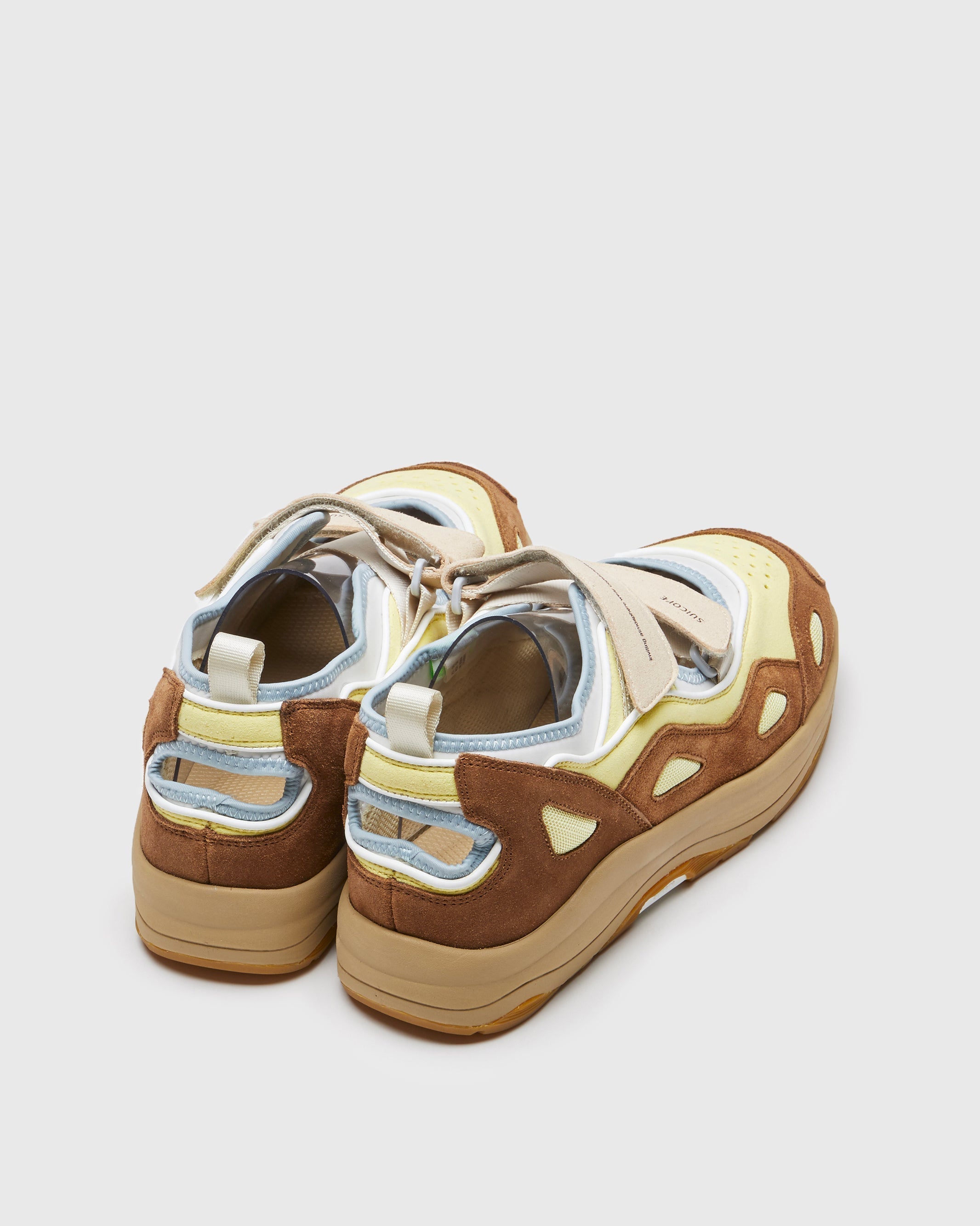 SUICOKE AKK-ab sneakers with brown & yellow nylon upper, brown & yellow midsole and sole, strap and logo patch. From Spring/Summer 2023 collection on SUICOKE Official US & Canada Webstore. OG-285AB BROWN X YELLOW