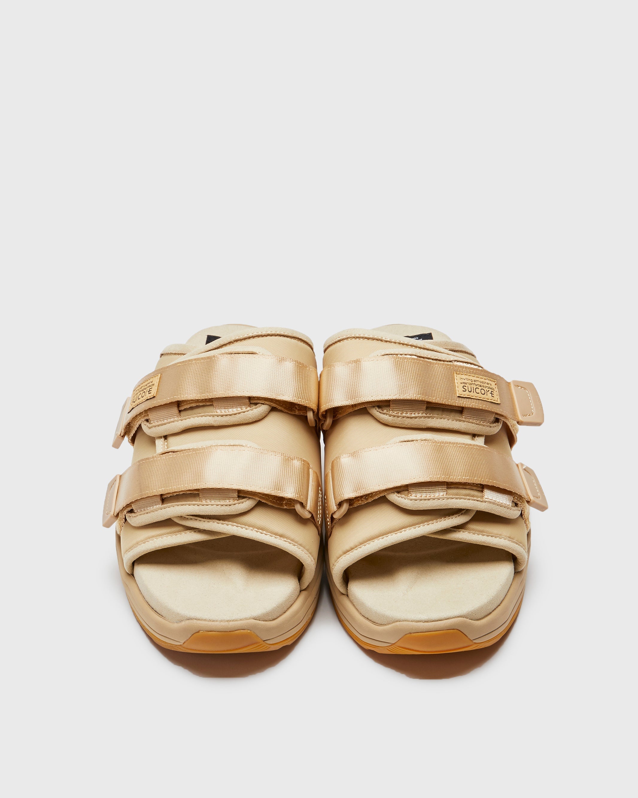 SUICOKE MOTO-Run slides with beige nylon upper, beige midsole and sole, strap and logo patch. From Spring/Summer 2023 collection on SUICOKE Official US & Canada Webstore. OG-332 BEIGE