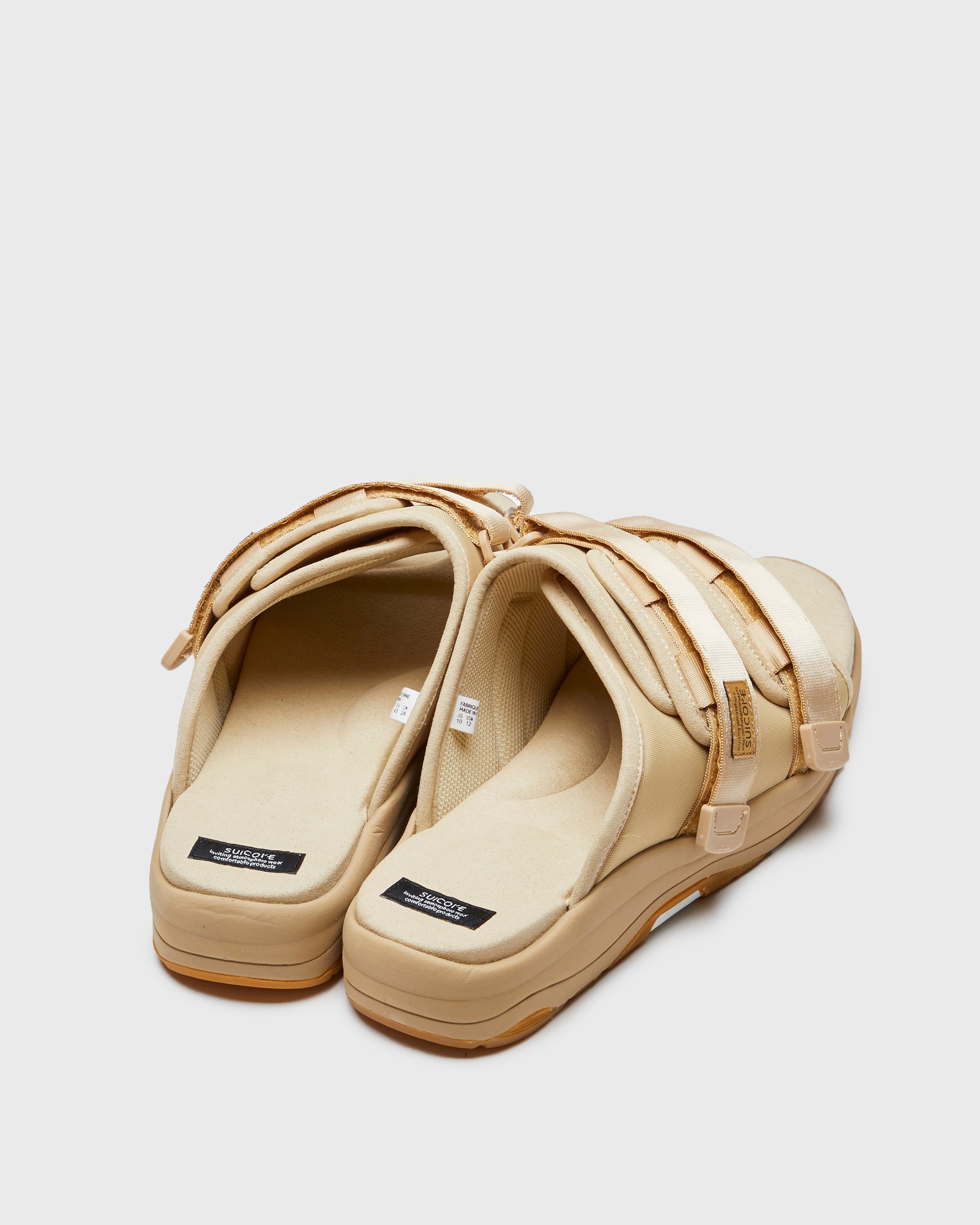 SUICOKE MOTO-Run slides with beige nylon upper, beige midsole and sole, strap and logo patch. From Spring/Summer 2023 collection on SUICOKE Official US & Canada Webstore. OG-332 BEIGE