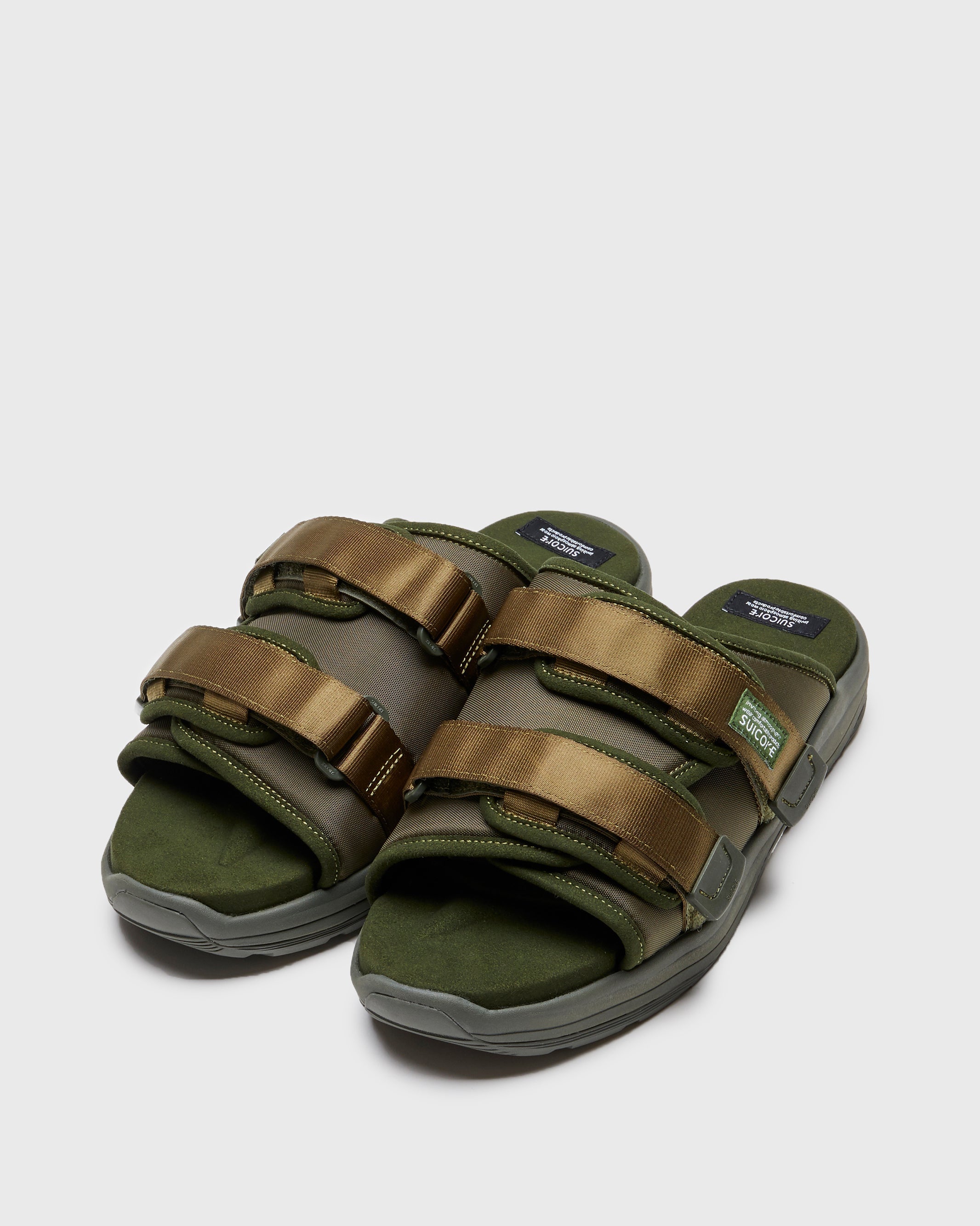 SUICOKE MOTO-Run slides with olive nylon upper, olive midsole and sole, strap and logo patch. From Spring/Summer 2023 collection on SUICOKE Official US & Canada Webstore. OG-332 OLIVE.