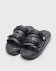 SUICOKE URICH slides with black rubber upper, black midsole and sole, straps and logo patch. From Spring/Summer 2022 collection on SUICOKE Official US & Canada Webstore. OG-INJ-01 BLACK