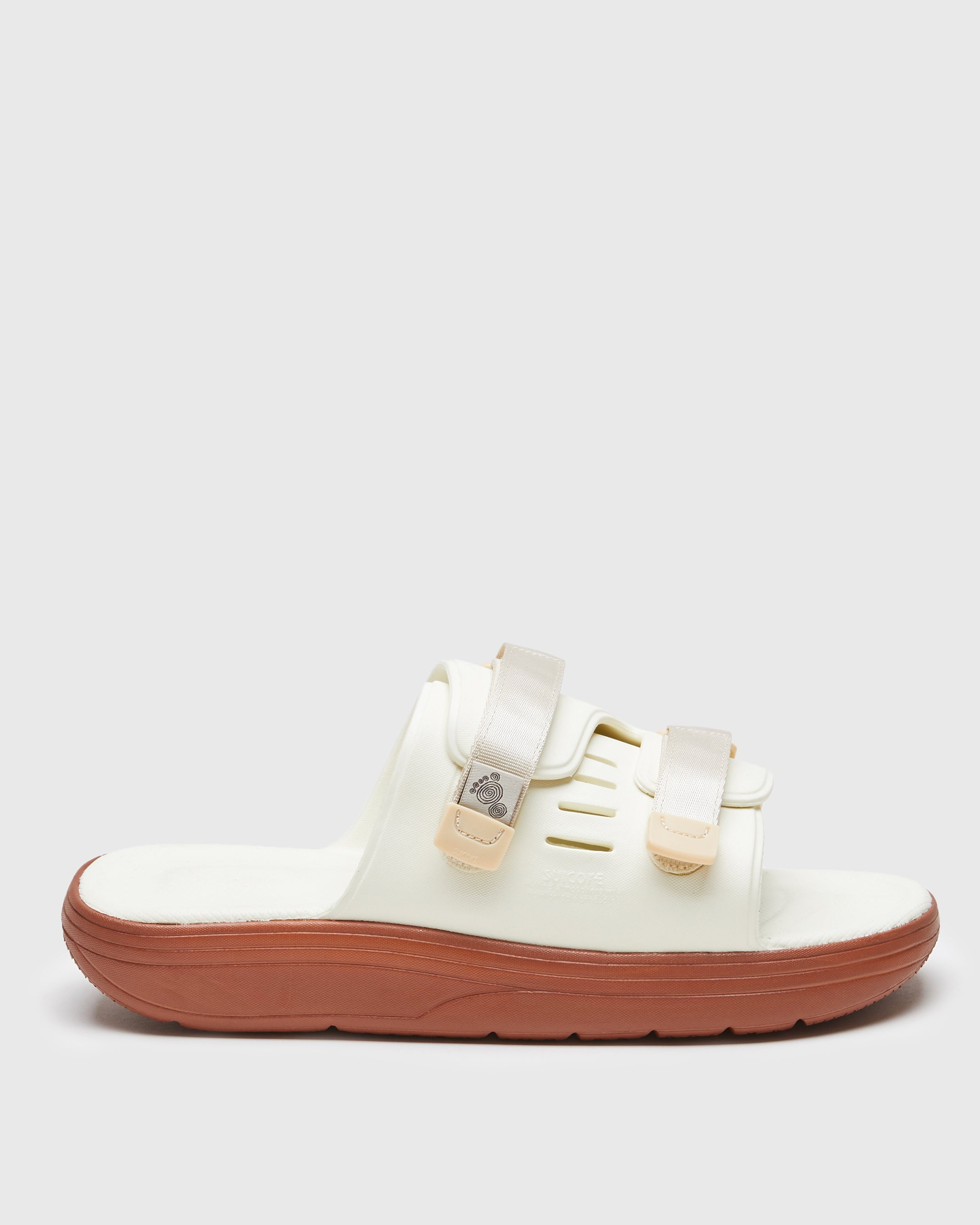 SUICOKE URICH slides with off-white rubber upper, off-white rubber midsole and sole, off white nylon strap and logo patch. From Spring/Summer 2023 collection on SUICOKE Official US & Canada Webstore. OG-INJ-01 OFF WHITE