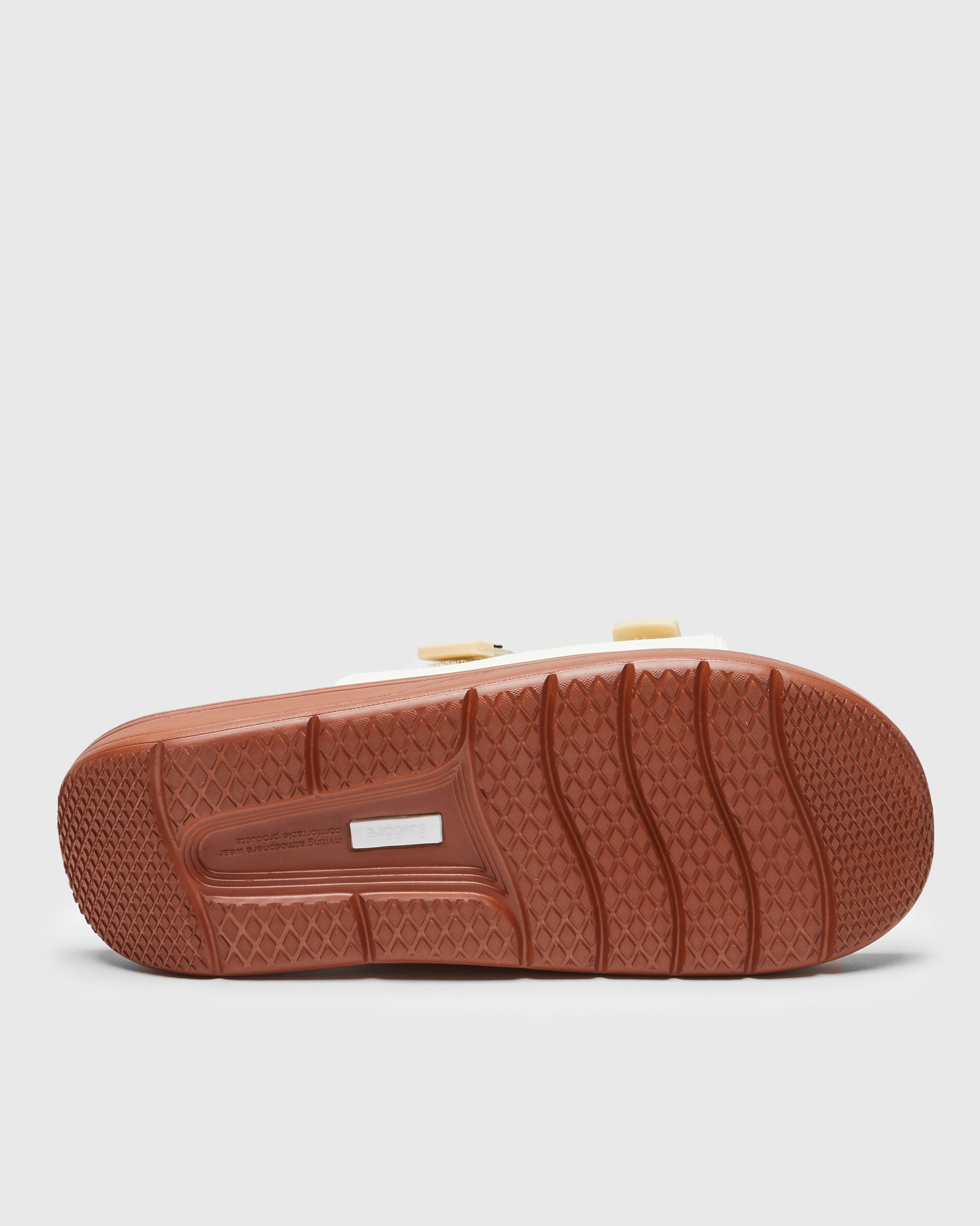 SUICOKE URICH slides with off-white rubber upper, off-white rubber midsole and sole, off white nylon strap and logo patch. From Spring/Summer 2023 collection on SUICOKE Official US & Canada Webstore. OG-INJ-01 OFF WHITE