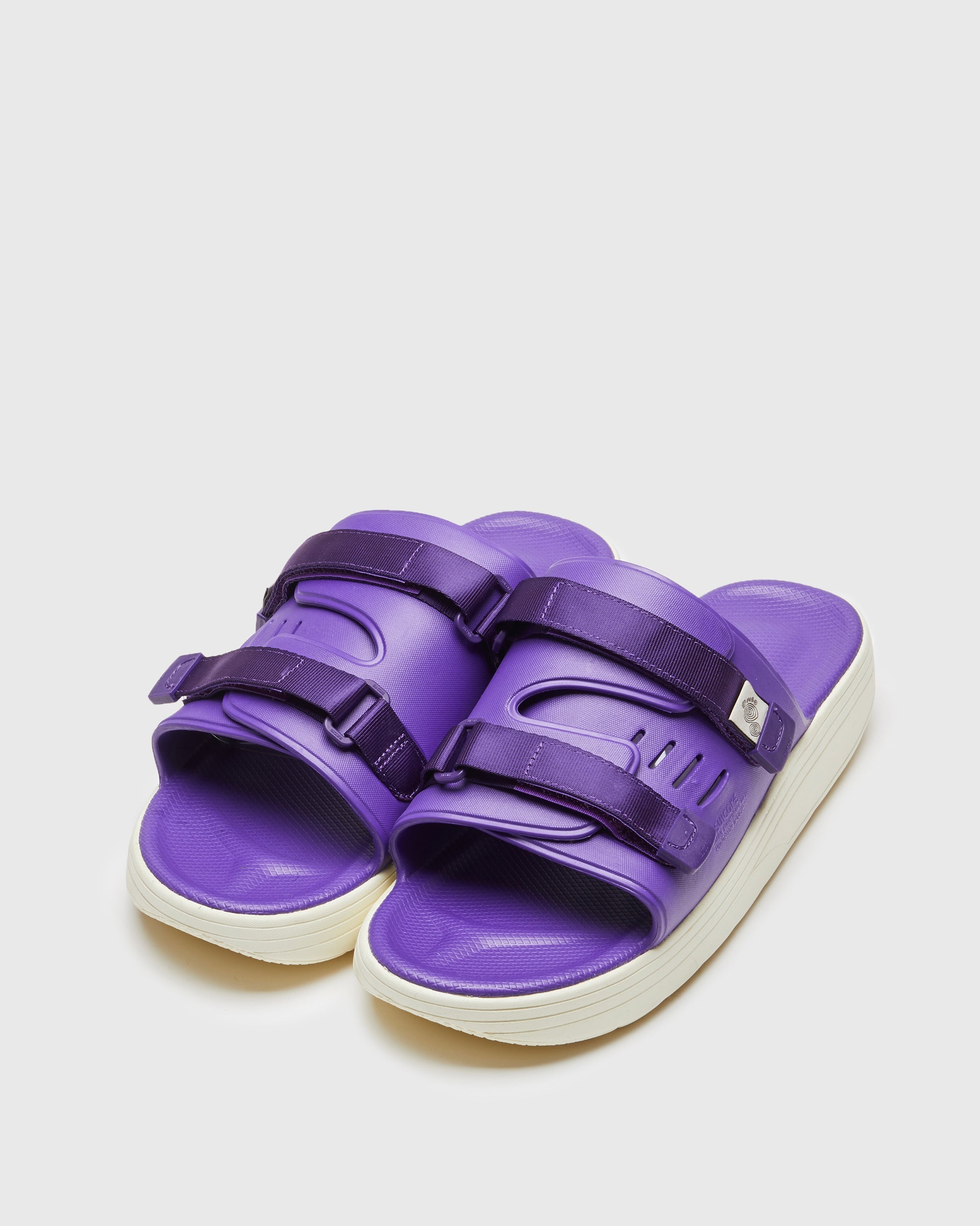 SUICOKE URICH slides with purple rubber upper, purple rubber midsole and sole, purple nylon strap and logo patch. From Spring/Summer 2023 collection on SUICOKE Official US & Canada Webstore. OG-INJ-01 PURPLE.