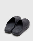 SUICOKE POLK slides with black rubber upper, black midsole and sole, straps and logo patch. From Spring/Summer 2022 collection on SUICOKE Official US & Canada Webstore. OG-INJ-04 BLACK