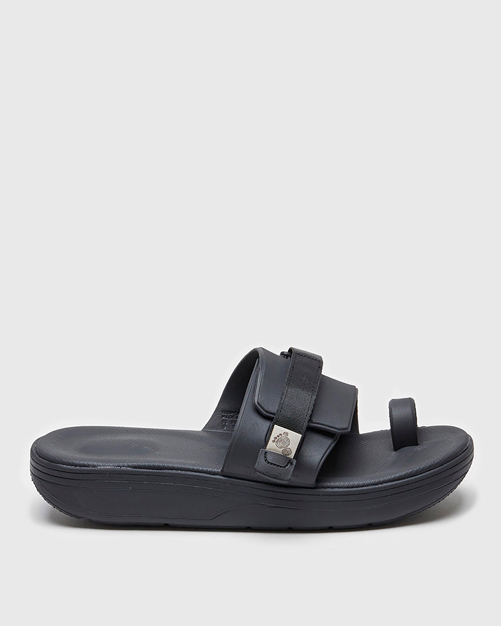 SUICOKE UTA slides with black rubber upper, black midsole and sole, straps and logo patch. From Spring/Summer 2022 collection on SUICOKE Official US & Canada Webstore.