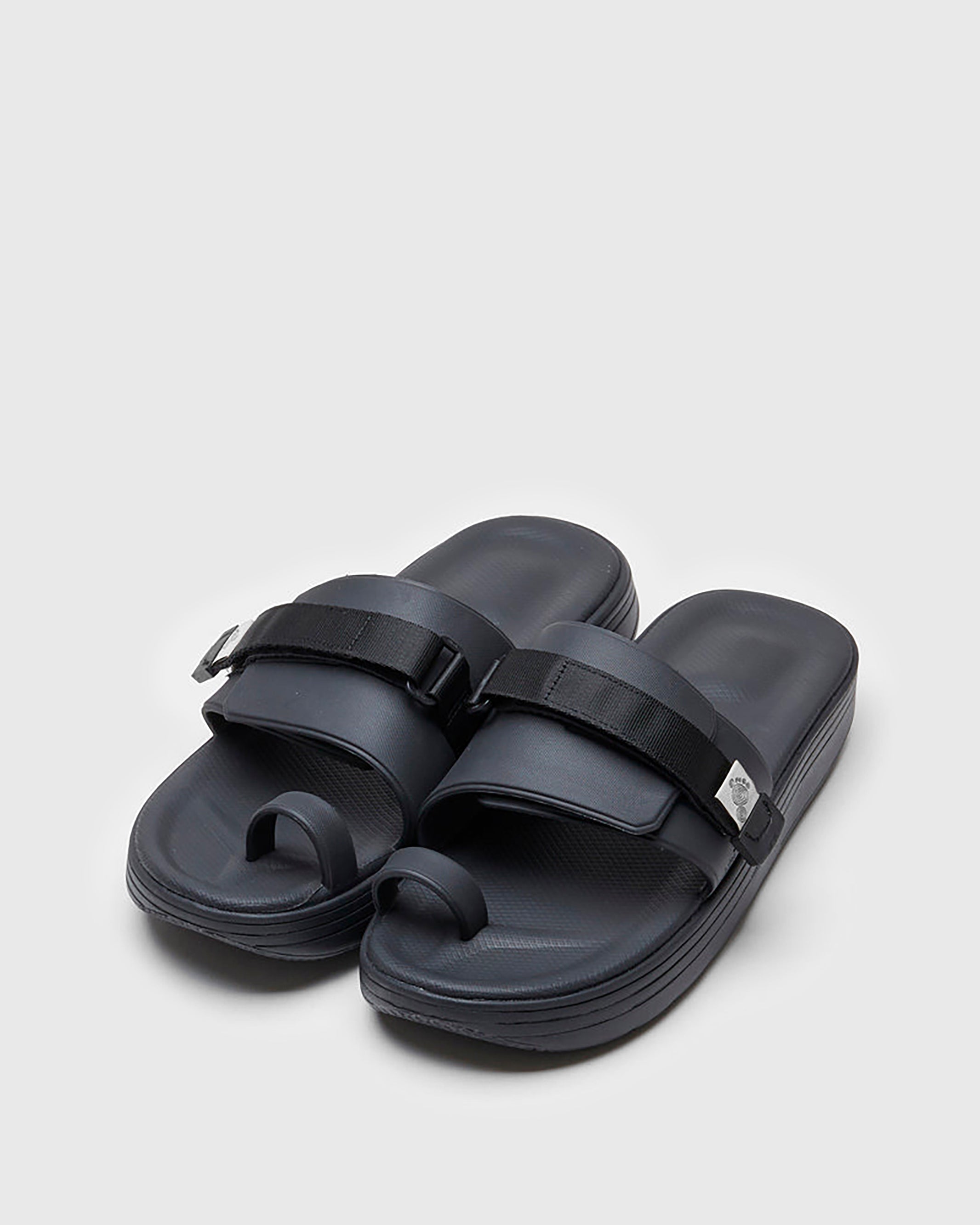 SUICOKE UTA slides with black rubber upper, black midsole and sole, straps and logo patch. From Spring/Summer 2022 collection on SUICOKE Official US & Canada Webstore.