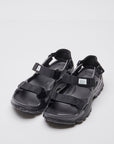 SUICOKE WAKE sandals with black rubber upper, black midsole and sole, straps and logo patch. From Spring/Summer 2023 collection on SUICOKE Official US & Canada Webstore. OG-INJ-100 BLACK