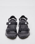 SUICOKE WAKE sandals with black rubber upper, black midsole and sole, straps and logo patch. From Spring/Summer 2023 collection on SUICOKE Official US & Canada Webstore. OG-INJ-100 BLACK