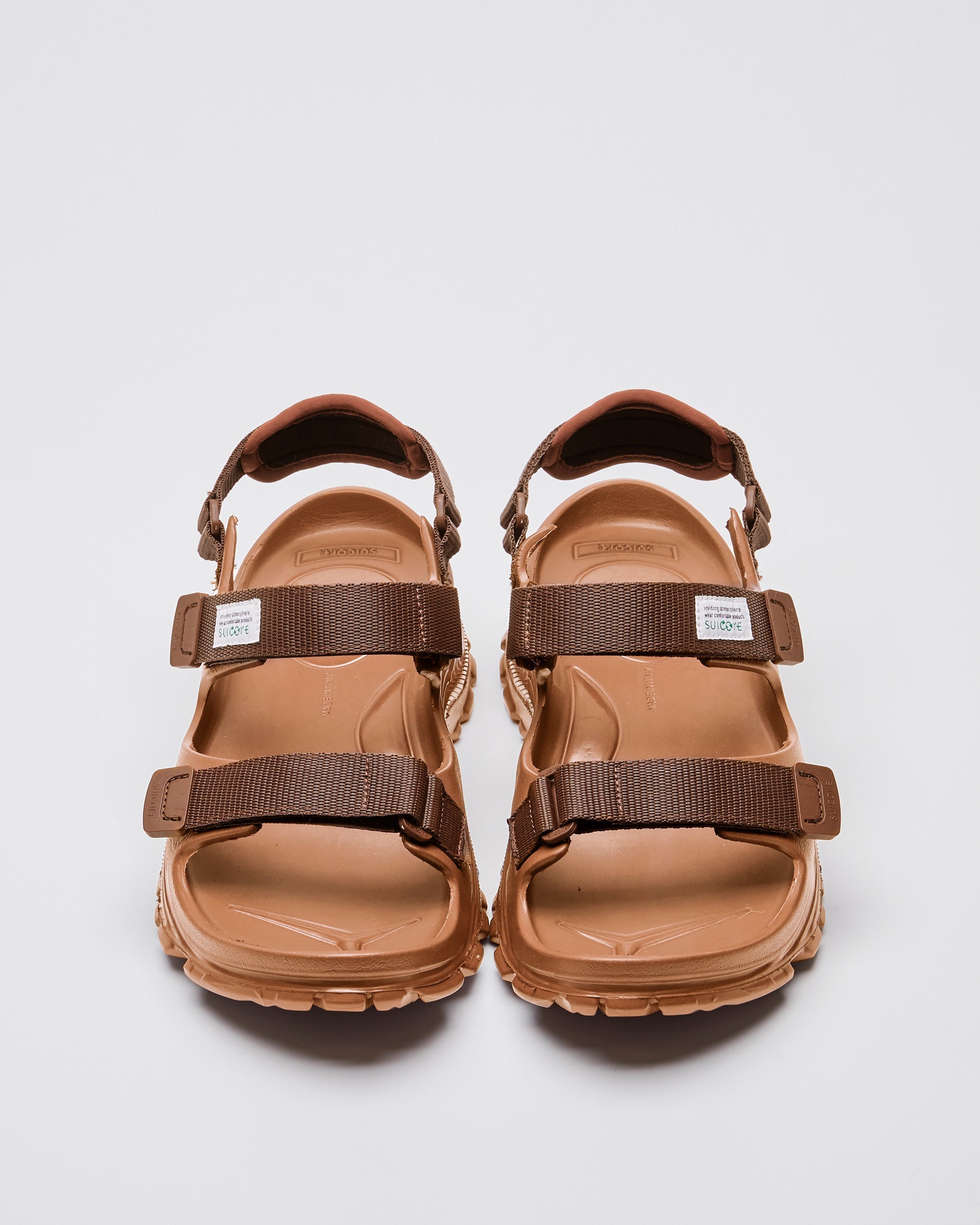 SUICOKE WAKE sandals with brown rubber upper, brown midsole and sole, straps and logo patch. From Spring/Summer 2023 collection on SUICOKE Official US & Canada Webstore. OG-INJ-100 BROWN