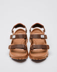 SUICOKE WAKE sandals with brown rubber upper, brown midsole and sole, straps and logo patch. From Spring/Summer 2023 collection on SUICOKE Official US & Canada Webstore. OG-INJ-100 BROWN