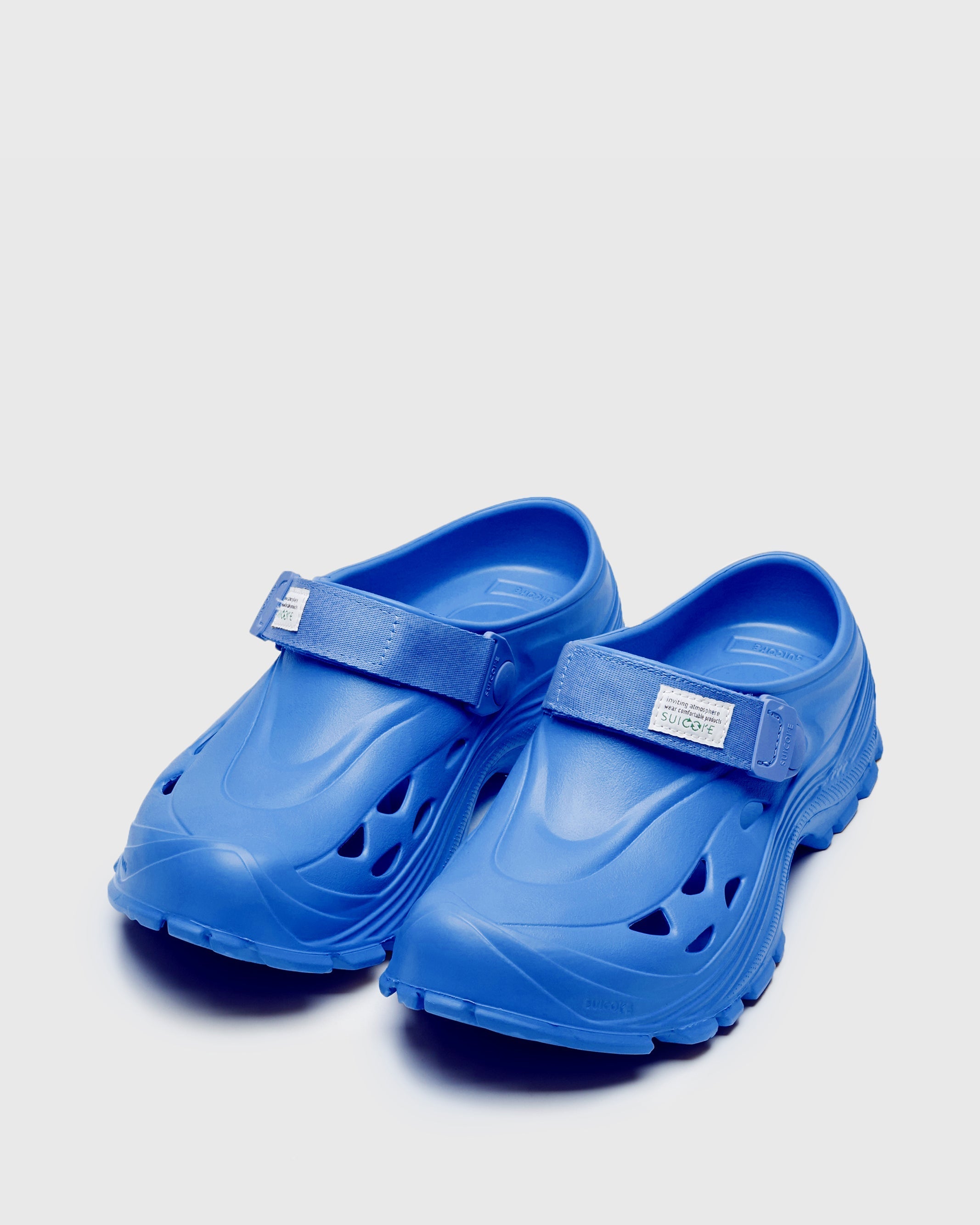 SUICOKE MOK slides with blue rubber upper, blue midsole and sole, straps and logo patch. From Spring/Summer 2023 collection on SUICOKE Official US & Canada Webstore. OG-INJ101 BLUE