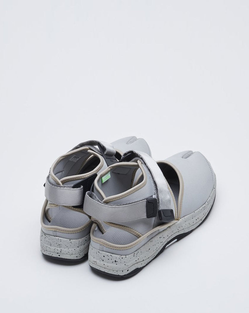 SUICOKE UNBITA-ab split toe shoe with gray nylon closed toe upper and ankle covering with gray straps and logo tag and gray running sole with black speckles. From Fall/Winter 2021 collection on SUICOKE Official US & Canada Webstore.