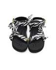 SUICOKE Depa-Fbcpocab-A black platform sandal with zebra printed straps + gold hardware logo tips. From SUICOKE SS21 collection.