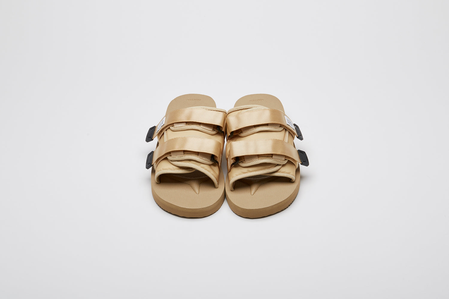 SUICOKE MOTO-Cab slides with beige nylon upper, beige midsole and sole, straps and logo patch. From Spring/Summer 2023 collection on eightywingold Web Store, an official partner of SUICOKE. OG-056CAB BEIGE