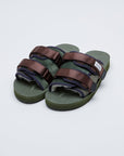 SUICOKE MOTO-Mab suede slides with green midsole and sole, green suede upper and shearling inside with navy piping and brown nylon straps with a logo patch. From Fall/Winter 2021 collection on SUICOKE Official US & Canada Webstore.
