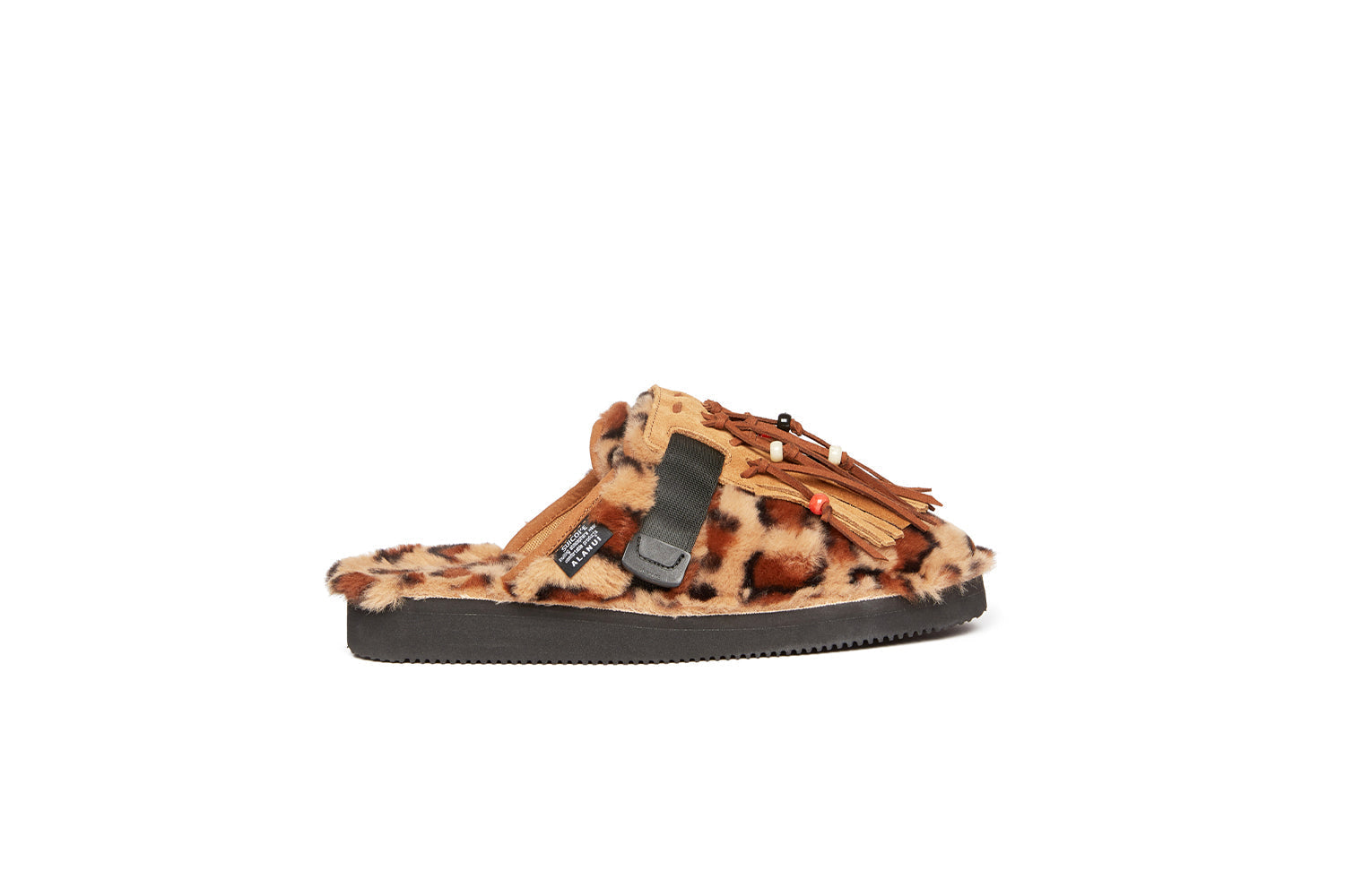Alanui edition SUICOKE Zavo closed toe slides with leopard spotted colored fur on the upper and footbed on a black sole. Includes a dark and light brown suede-beaded fringe that is a detachable piece from the singular nylon strap across the upper. From Fall/Winter 2021 collection on SUICOKE Official US &amp; Canada Webstore.