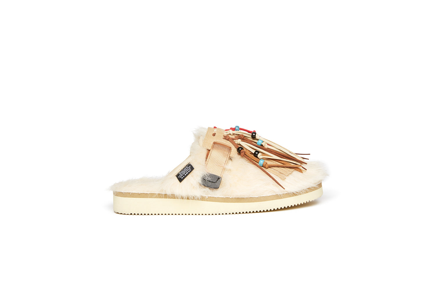 Alanui edition SUICOKE Zavo closed toe slides with ivory colored fur on the upper and footbed. Includes a beige and ivory suede-beaded fringe that is a detachable piece from the singular nylon strap across the upper. From Fall/Winter 2021 collection on SUICOKE Official US &amp; Canada Webstore.