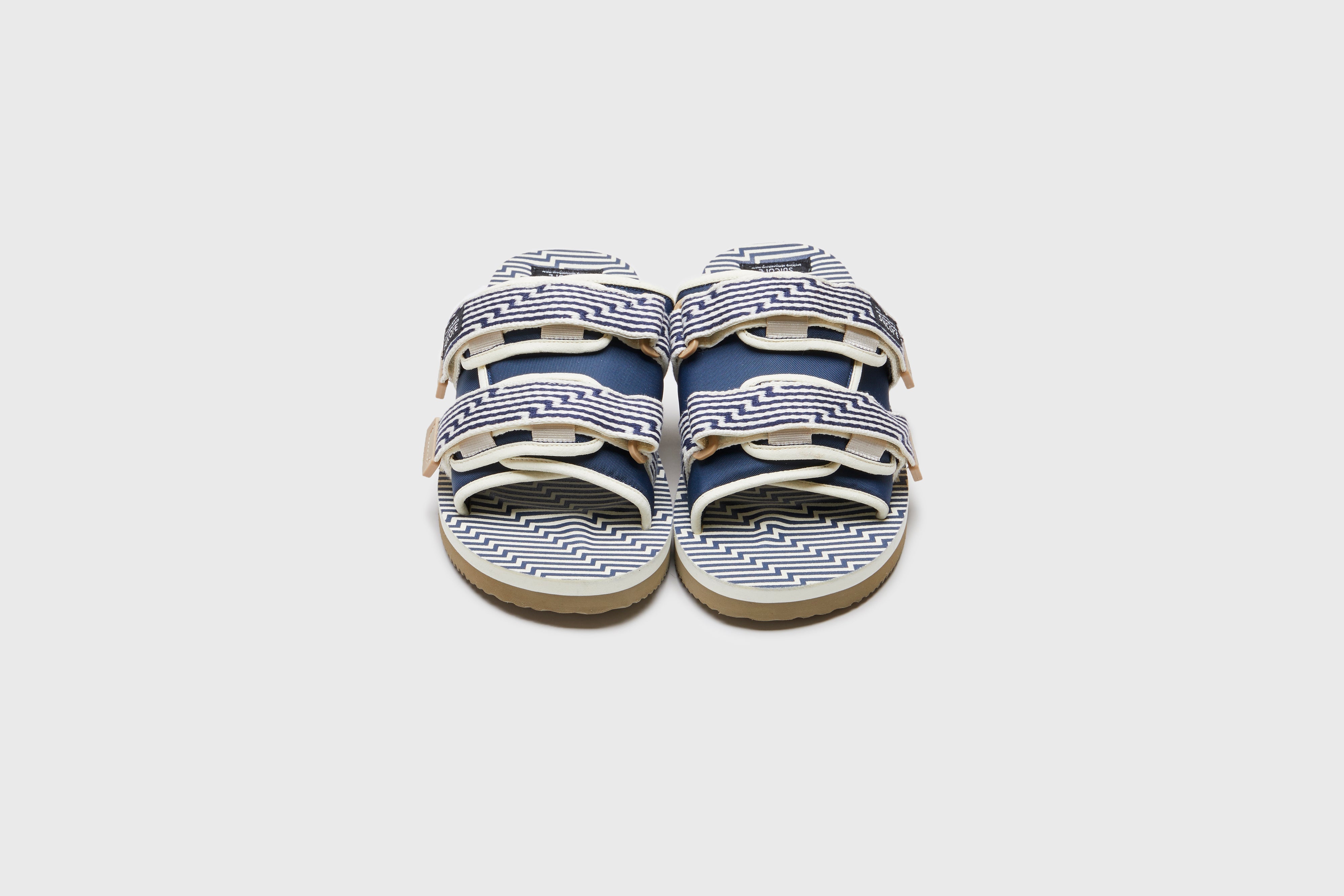 SUICOKE MOTO-JC01 slides with ivory &amp; navy nylon upper, ivory &amp; navy midsole and sole, strap and logo patch. From Spring/Summer 2023 collection on eightywingold Web Store, an official partner of SUICOKE. OG-056-JC01 IVORY X NAVY