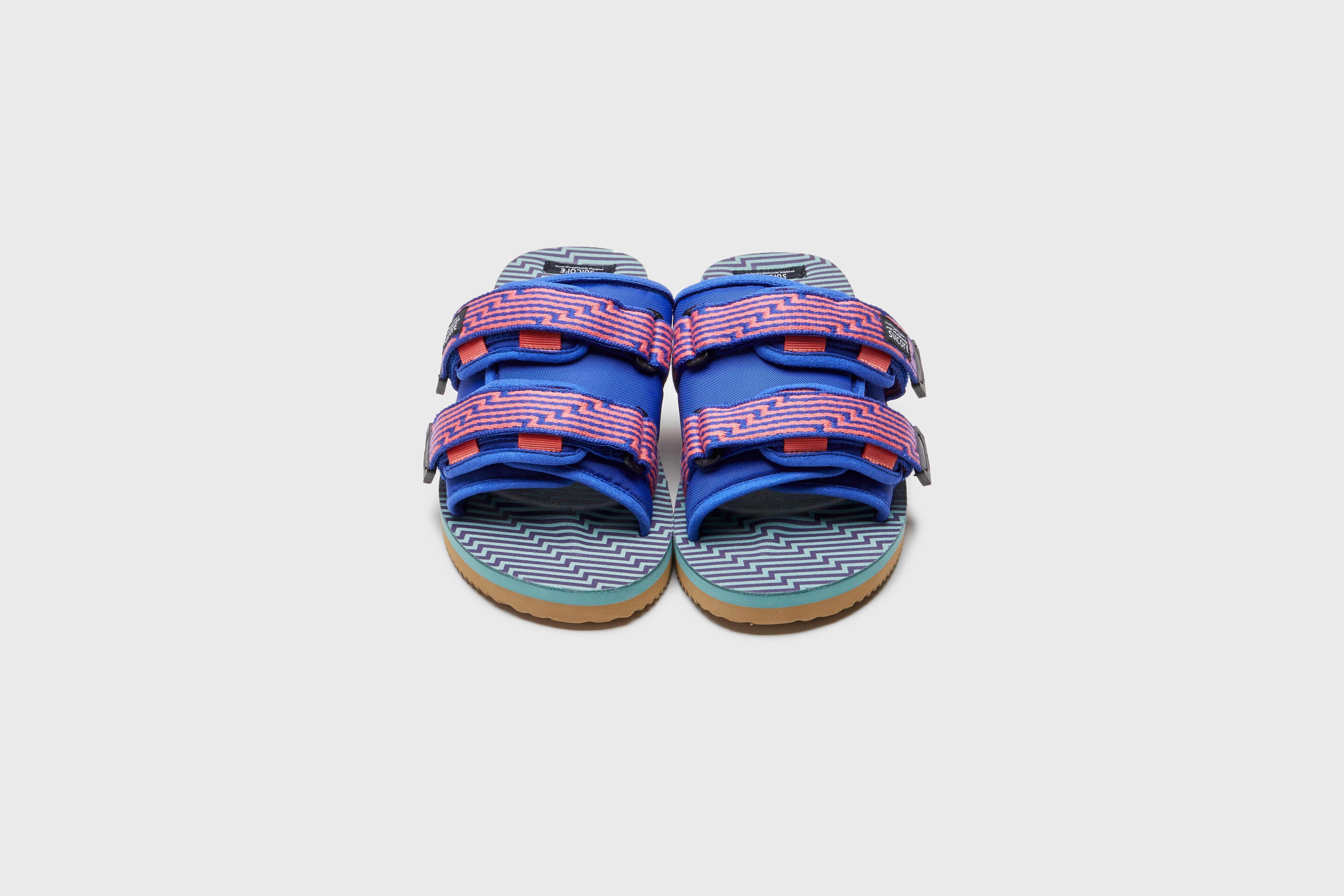 SUICOKE MOTO-JC01 slides with orange &amp; blue nylon upper, orange &amp; blue midsole and sole, strap and logo patch. From Spring/Summer 2023 collection on eightywingold Web Store, an official partner of SUICOKE. OG-056-JC01 ORANGE X BLUE