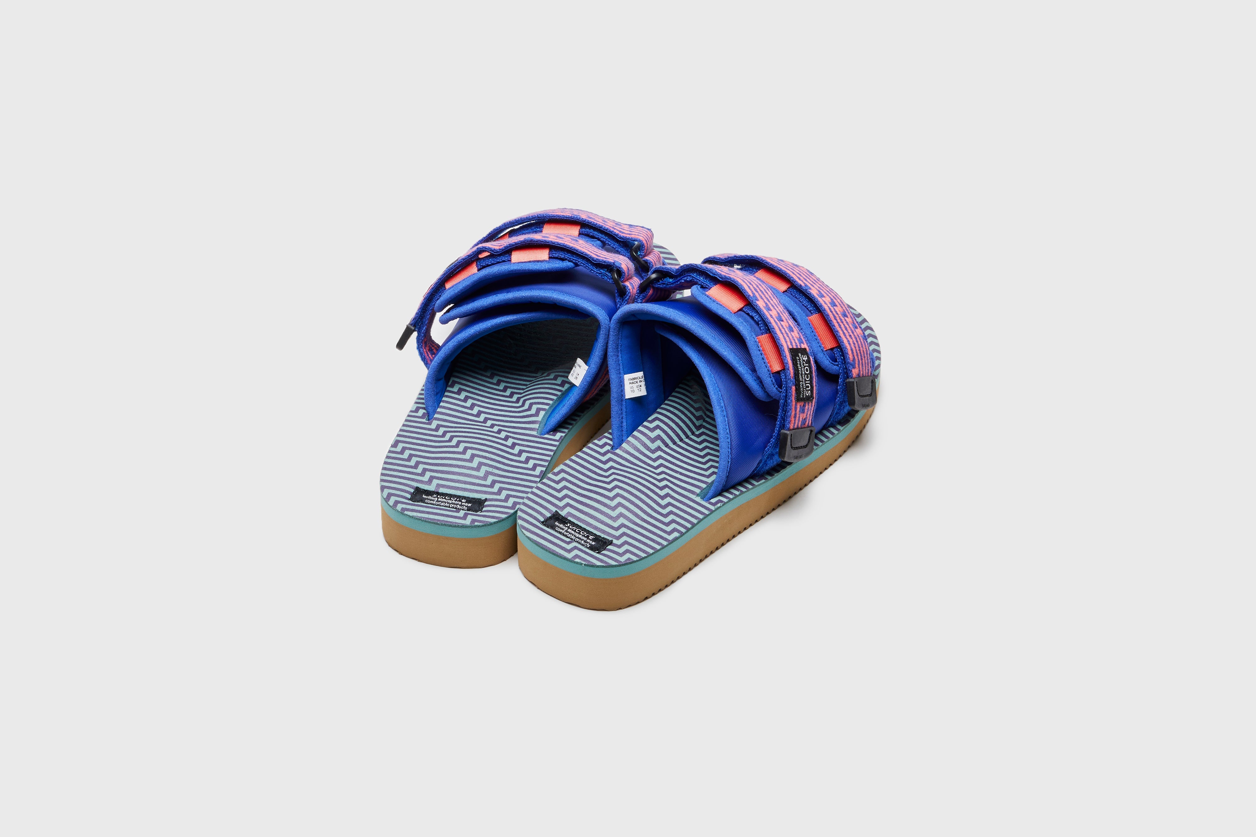 SUICOKE MOTO-JC01 slides with orange &amp; blue nylon upper, orange &amp; blue midsole and sole, strap and logo patch. From Spring/Summer 2023 collection on eightywingold Web Store, an official partner of SUICOKE. OG-056-JC01 ORANGE X BLUE