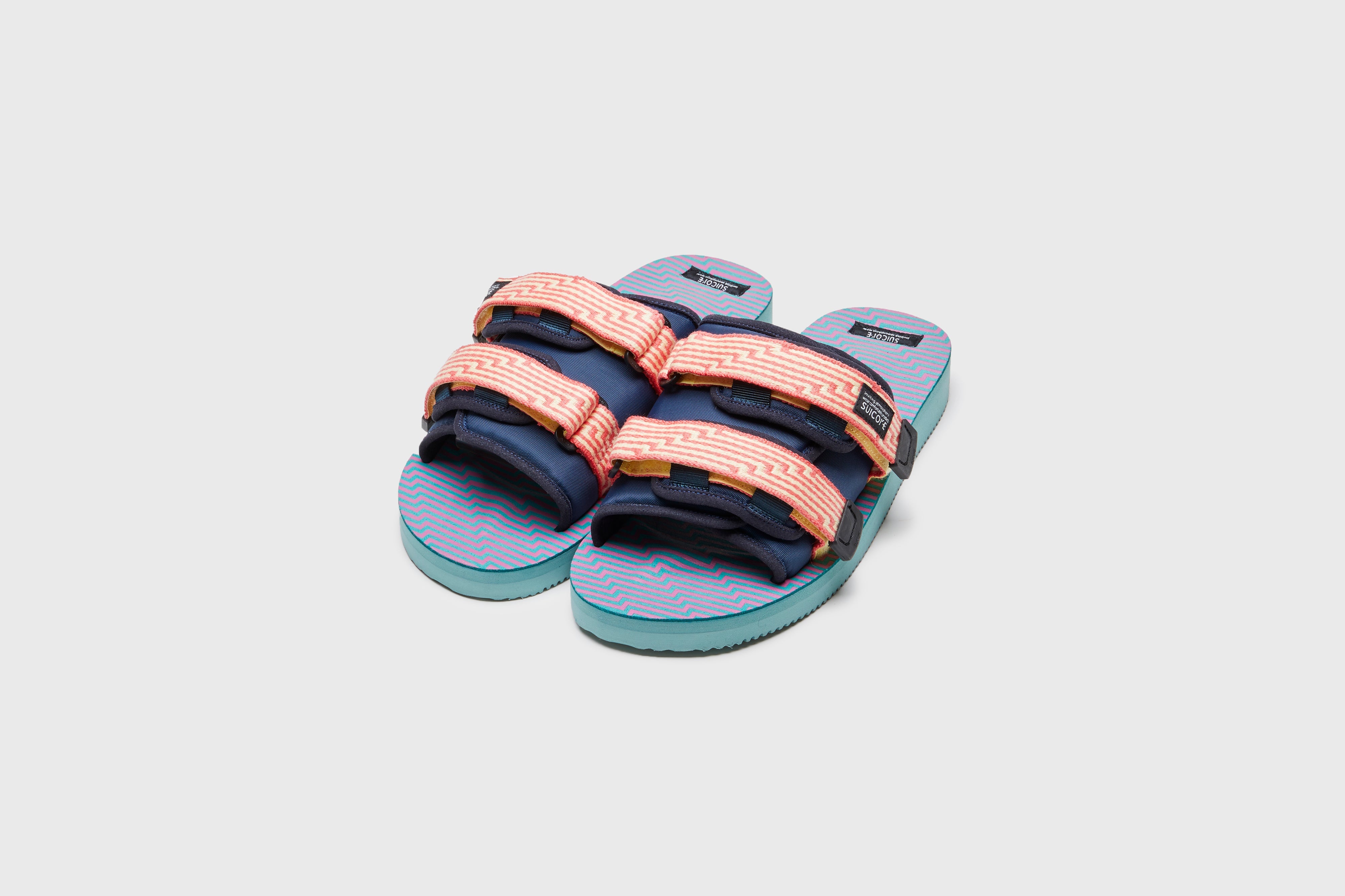 SUICOKE MOTO-JC01 slides with yellow &amp; pink nylon upper, yellow &amp; pink midsole and sole, strap and logo patch. From Spring/Summer 2023 collection on eightywingold Web Store, an official partner of SUICOKE. OG-056-JC01 YELLOW X PINK