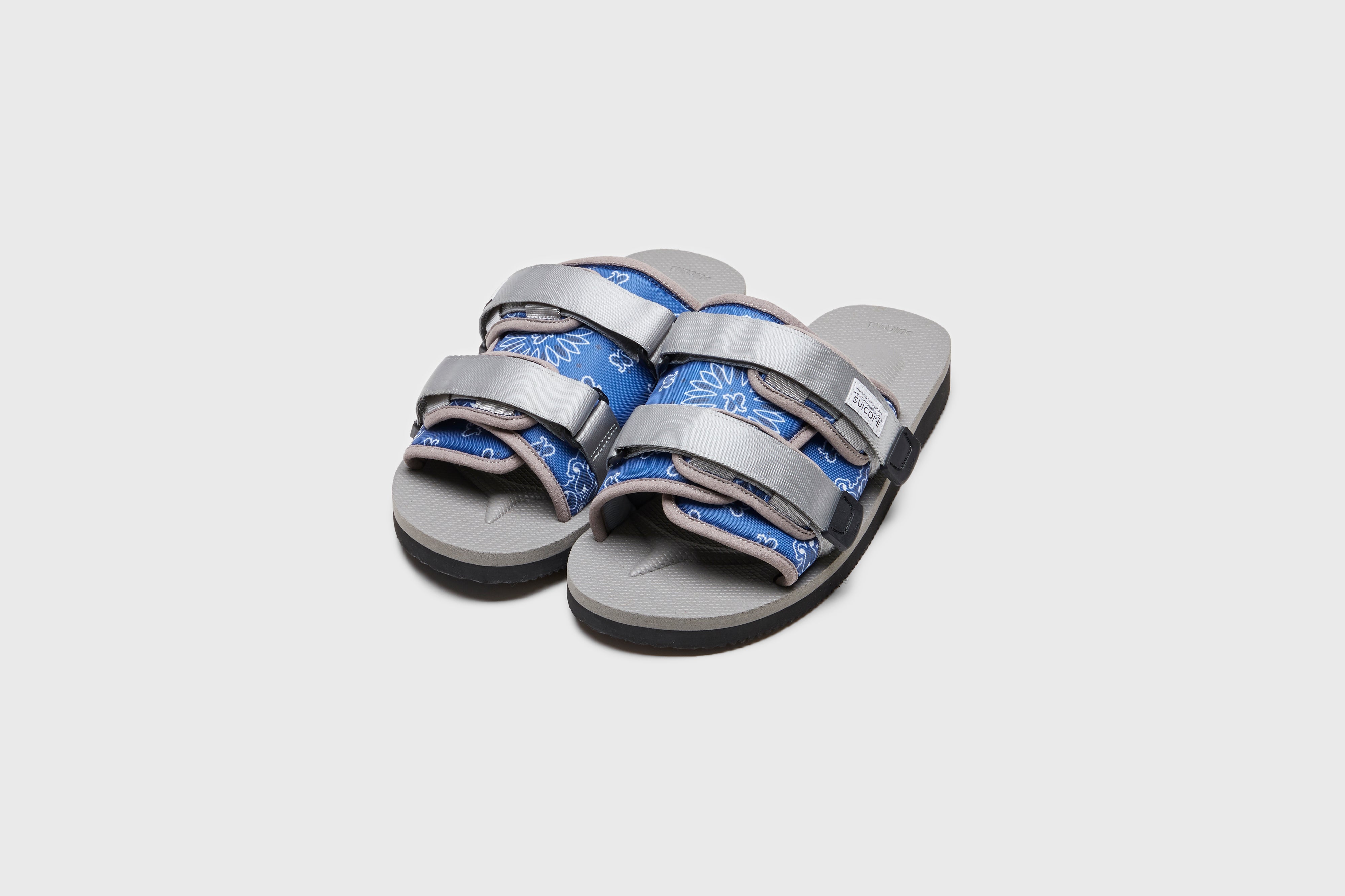 SUICOKE MOTO-Cab-PT05 slides with navy &amp; gray nylon upper, navy &amp; gray midsole and sole, strap and logo patch. From Spring/Summer 2023 collection on eightywingold Web Store, an official partner of SUICOKE. OG-056CAB-PT05 NAVY X GRAY