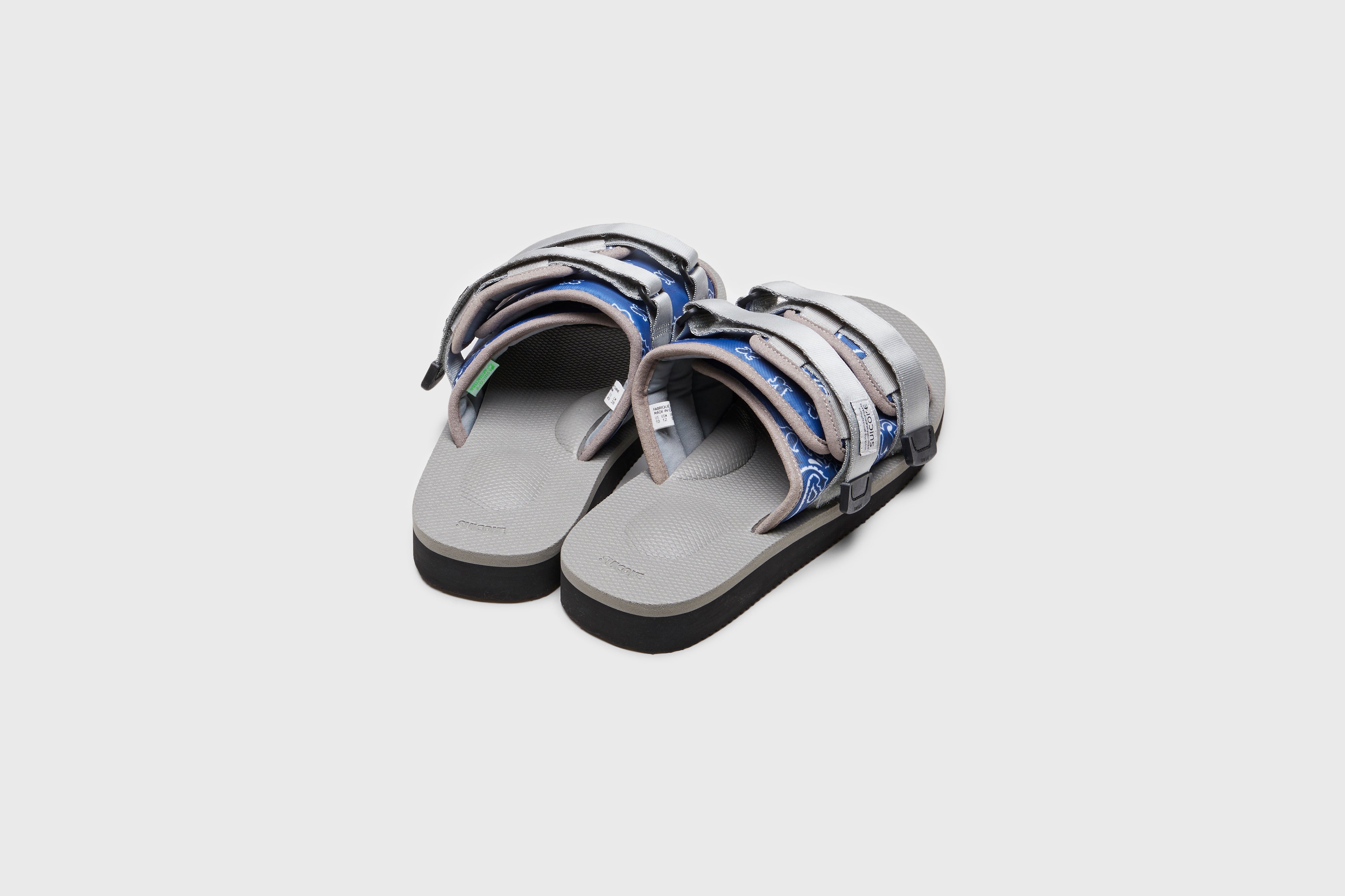 SUICOKE MOTO-Cab-PT05 slides with navy &amp; gray nylon upper, navy &amp; gray midsole and sole, strap and logo patch. From Spring/Summer 2023 collection on eightywingold Web Store, an official partner of SUICOKE. OG-056CAB-PT05 NAVY X GRAY