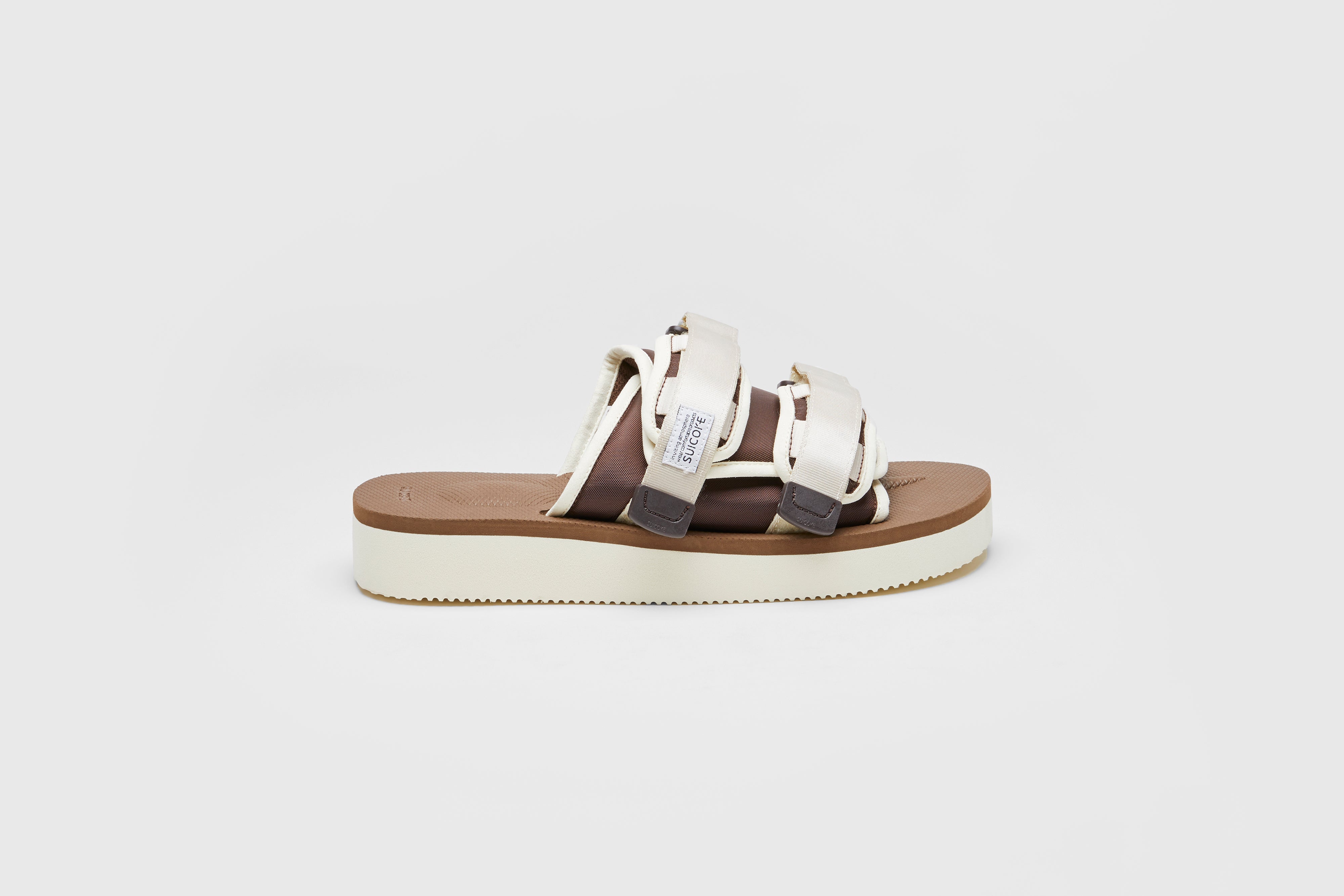 SUICOKE MOTO-PO slides with ivory & brown nylon upper, ivory & brown midsole and sole, strap and logo patch. From Spring/Summer 2023 collection on eightywingold Web Store, an official partner of SUICOKE. OG-056PO IVORY X BROWN