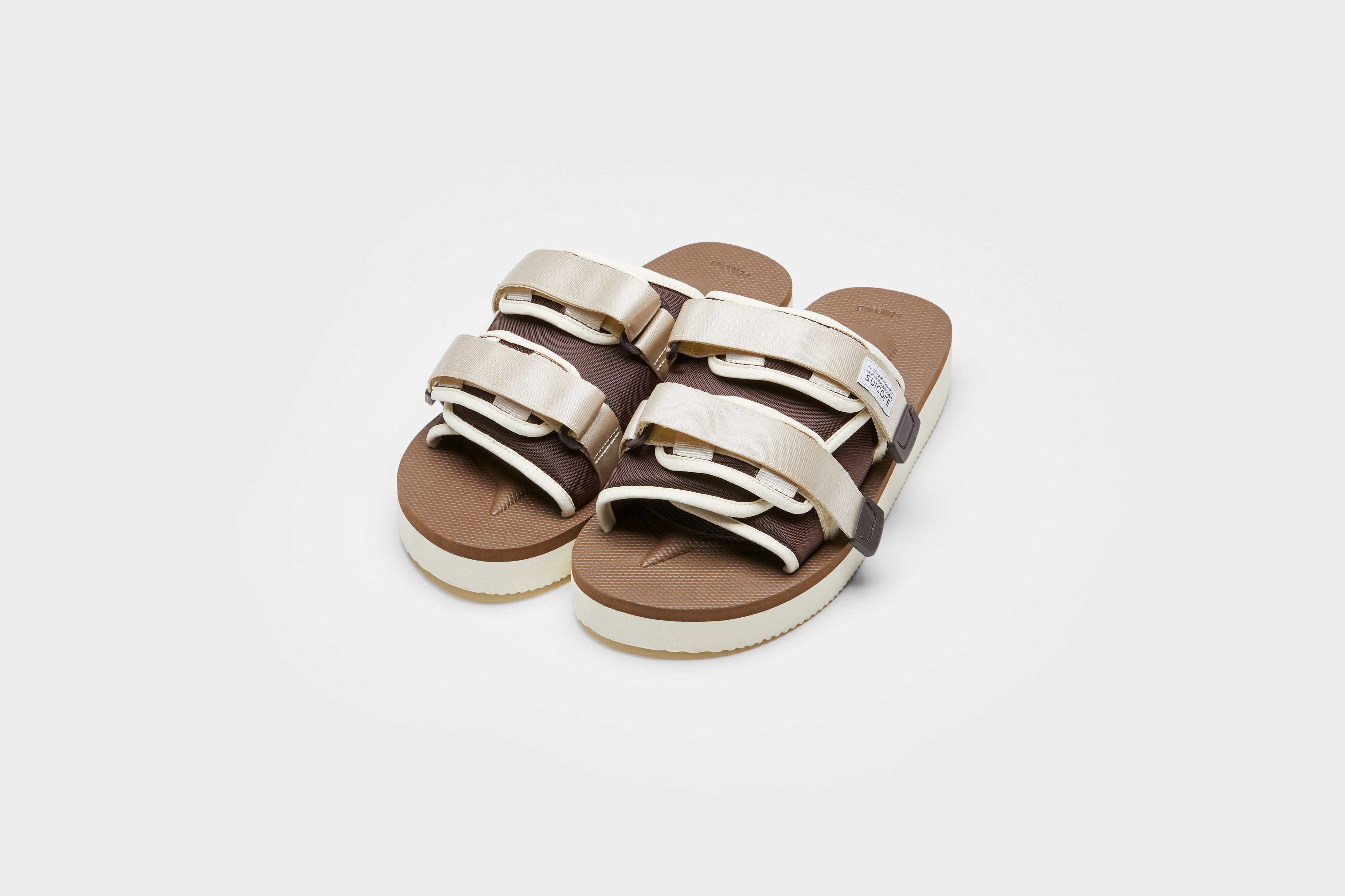 SUICOKE MOTO-PO slides with ivory & brown nylon upper, ivory & brown midsole and sole, strap and logo patch. From Spring/Summer 2023 collection on eightywingold Web Store, an official partner of SUICOKE. OG-056PO IVORY X BROWN