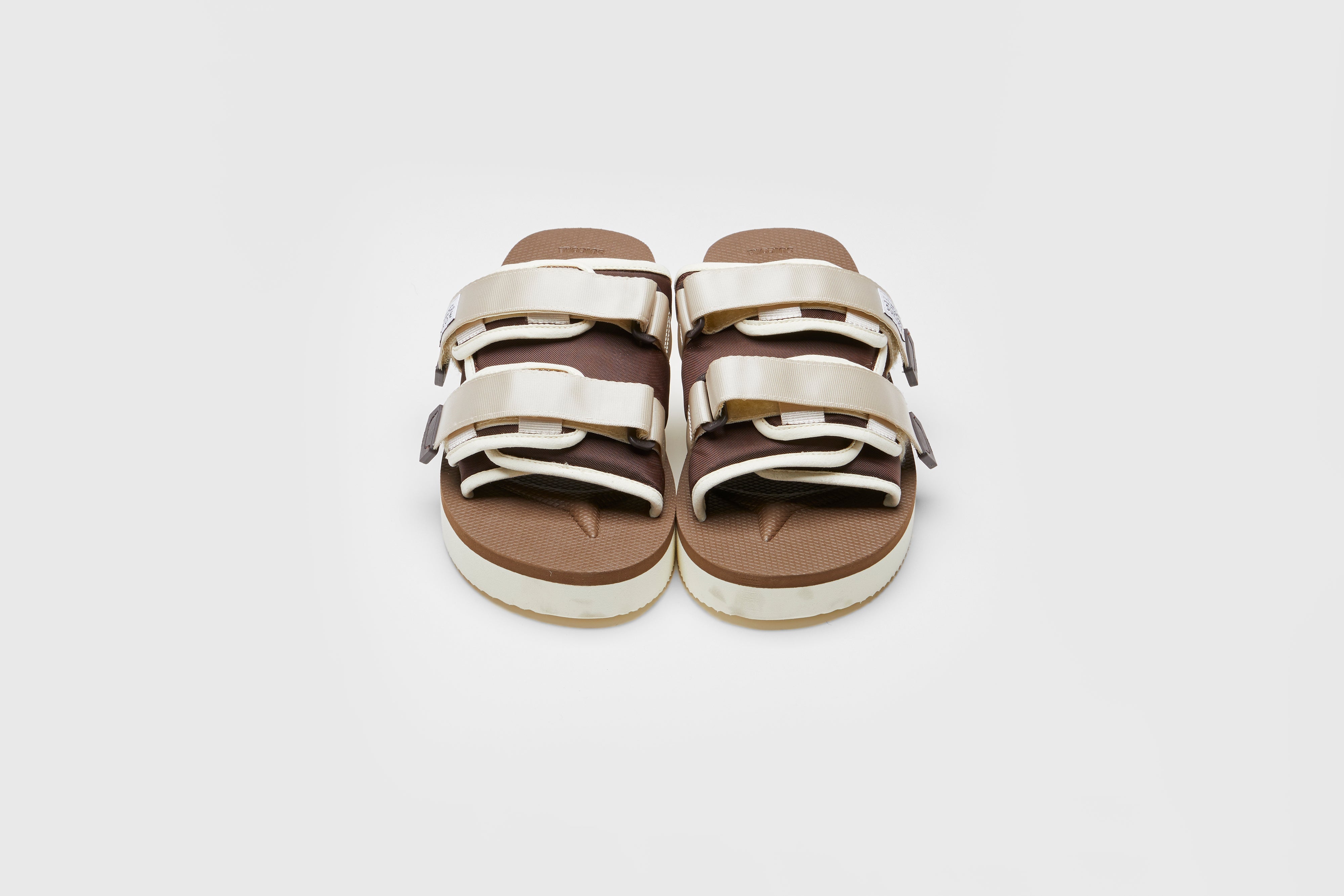 SUICOKE MOTO-PO slides with ivory &amp; brown nylon upper, ivory &amp; brown midsole and sole, strap and logo patch. From Spring/Summer 2023 collection on eightywingold Web Store, an official partner of SUICOKE. OG-056PO IVORY X BROWN