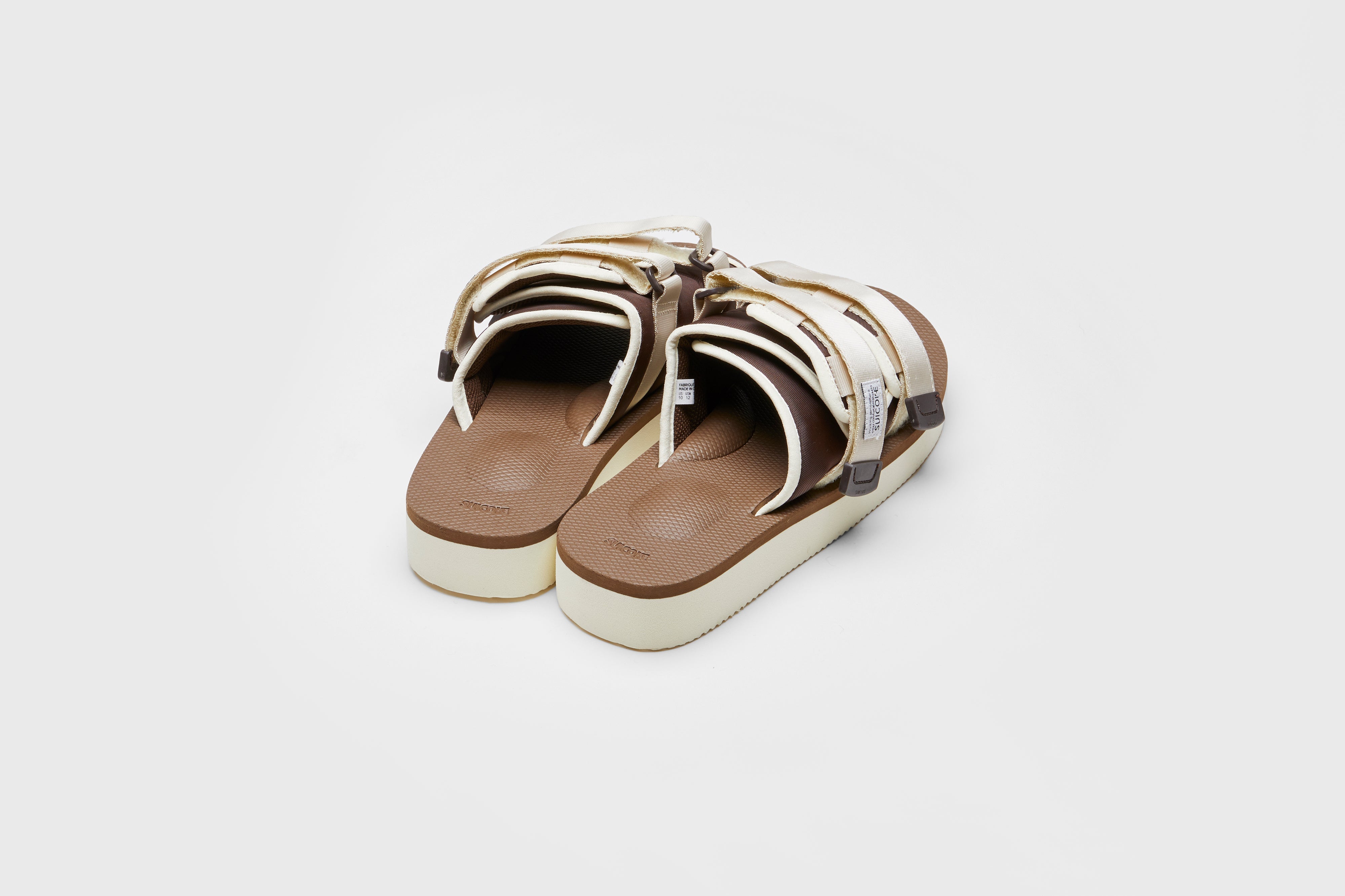 SUICOKE MOTO-PO slides with ivory &amp; brown nylon upper, ivory &amp; brown midsole and sole, strap and logo patch. From Spring/Summer 2023 collection on eightywingold Web Store, an official partner of SUICOKE. OG-056PO IVORY X BROWN