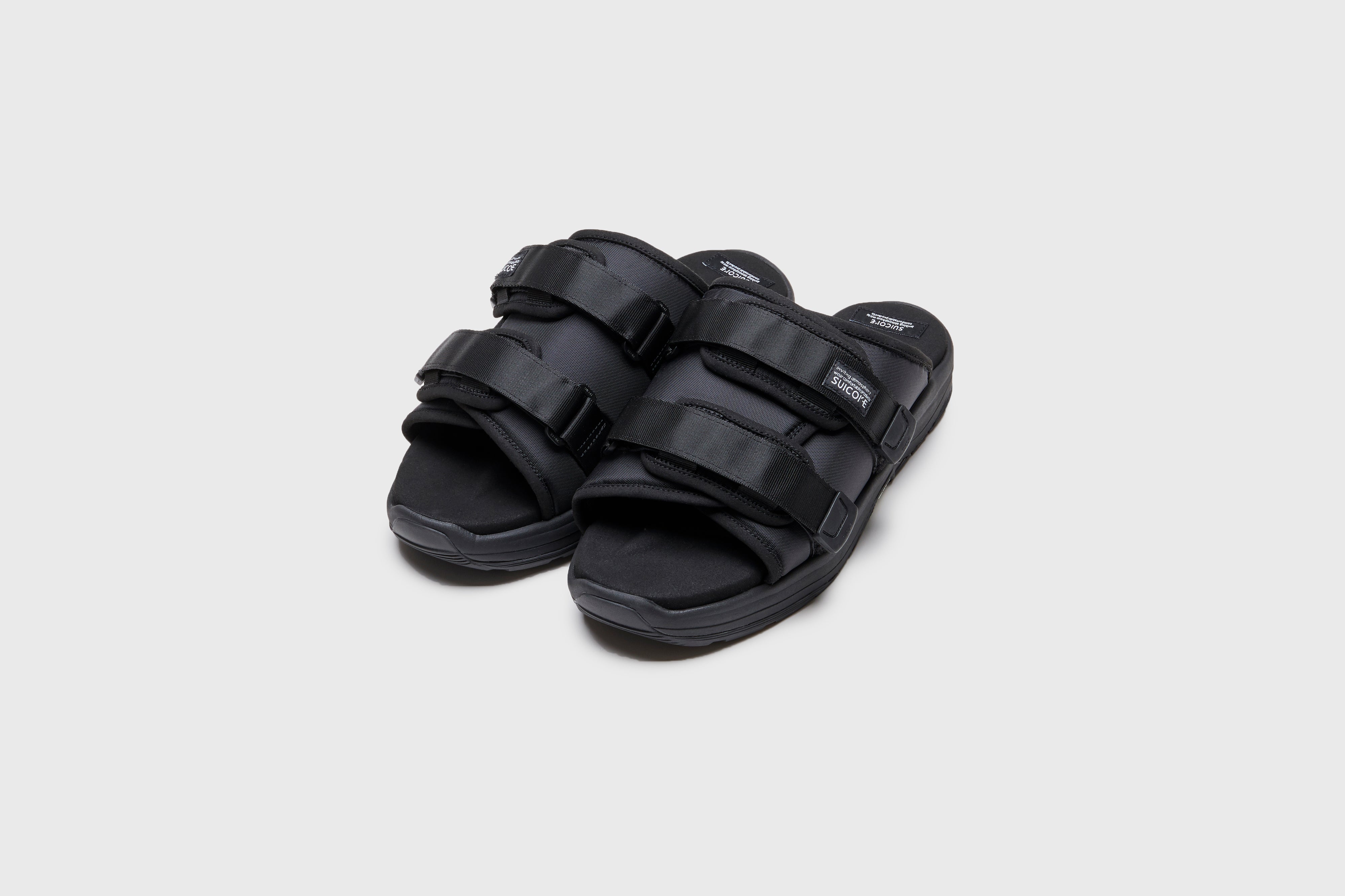 SUICOKE MOTO-Run slides with black nylon upper, black midsole and sole, strap and logo patch. From Spring/Summer 2023 collection on eightywingold Web Store, an official partner of SUICOKE. OG-332 BLACK