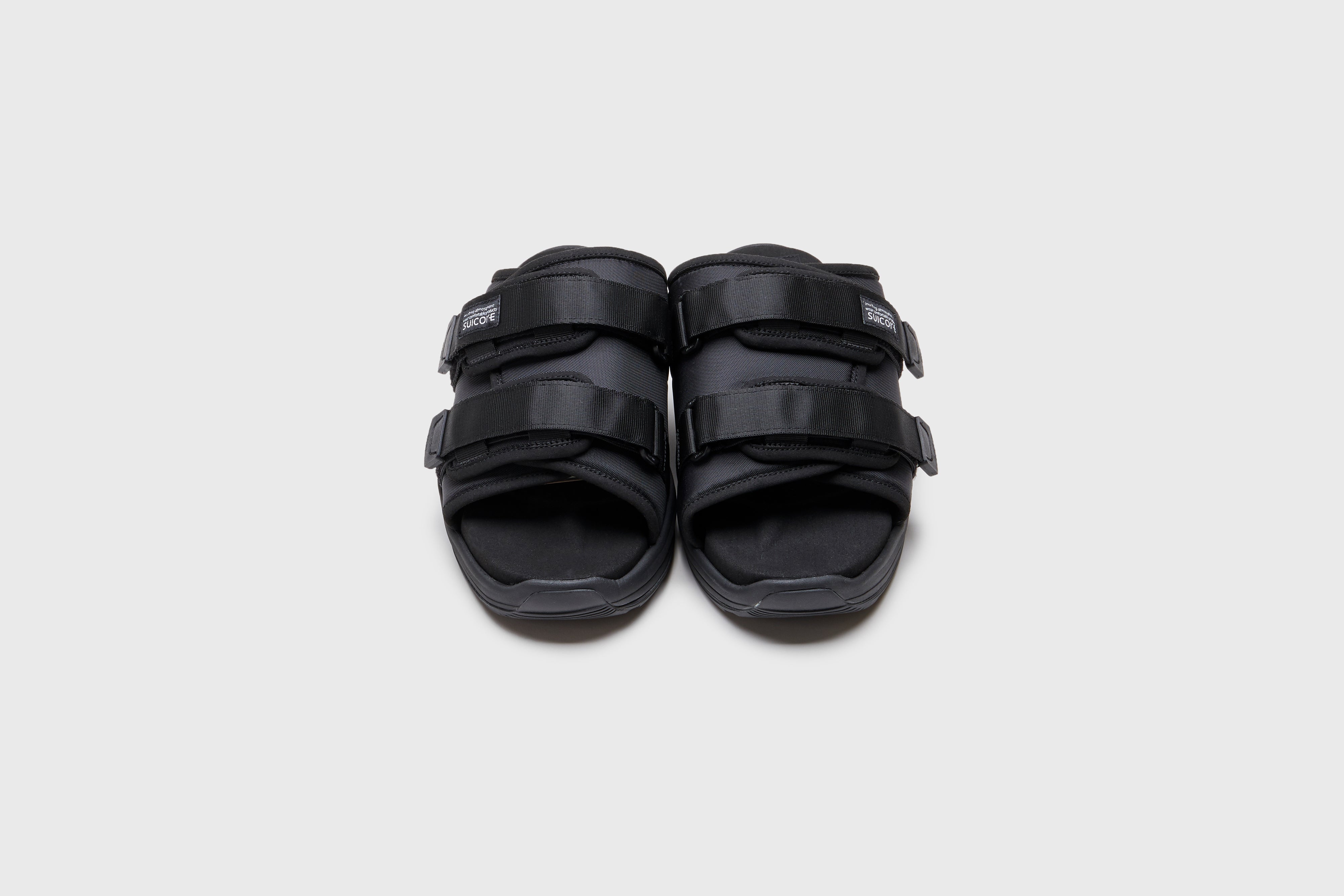 SUICOKE MOTO-Run slides with black nylon upper, black midsole and sole, strap and logo patch. From Spring/Summer 2023 collection on eightywingold Web Store, an official partner of SUICOKE. OG-332 BLACK